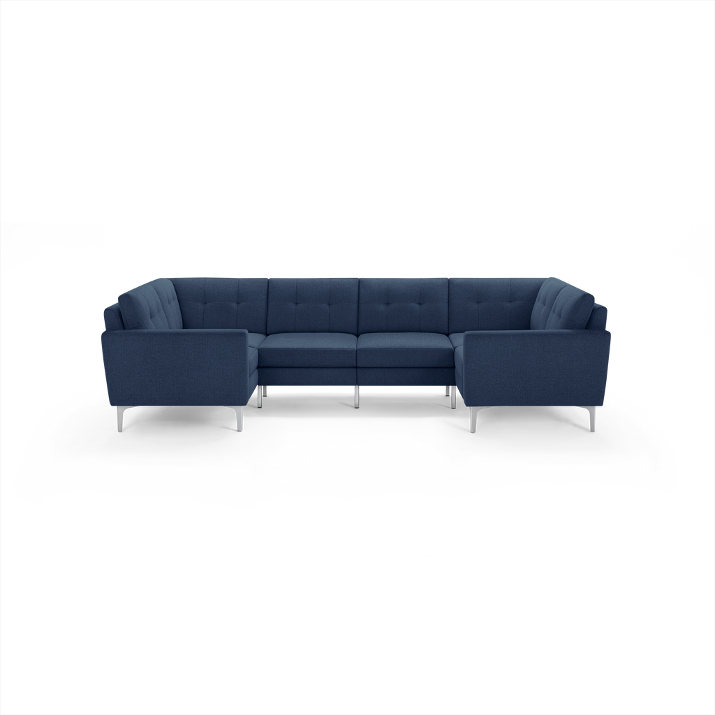 Modern navy blue U-shaped sectional sofa with tufted back cushions and sleek metal legs.