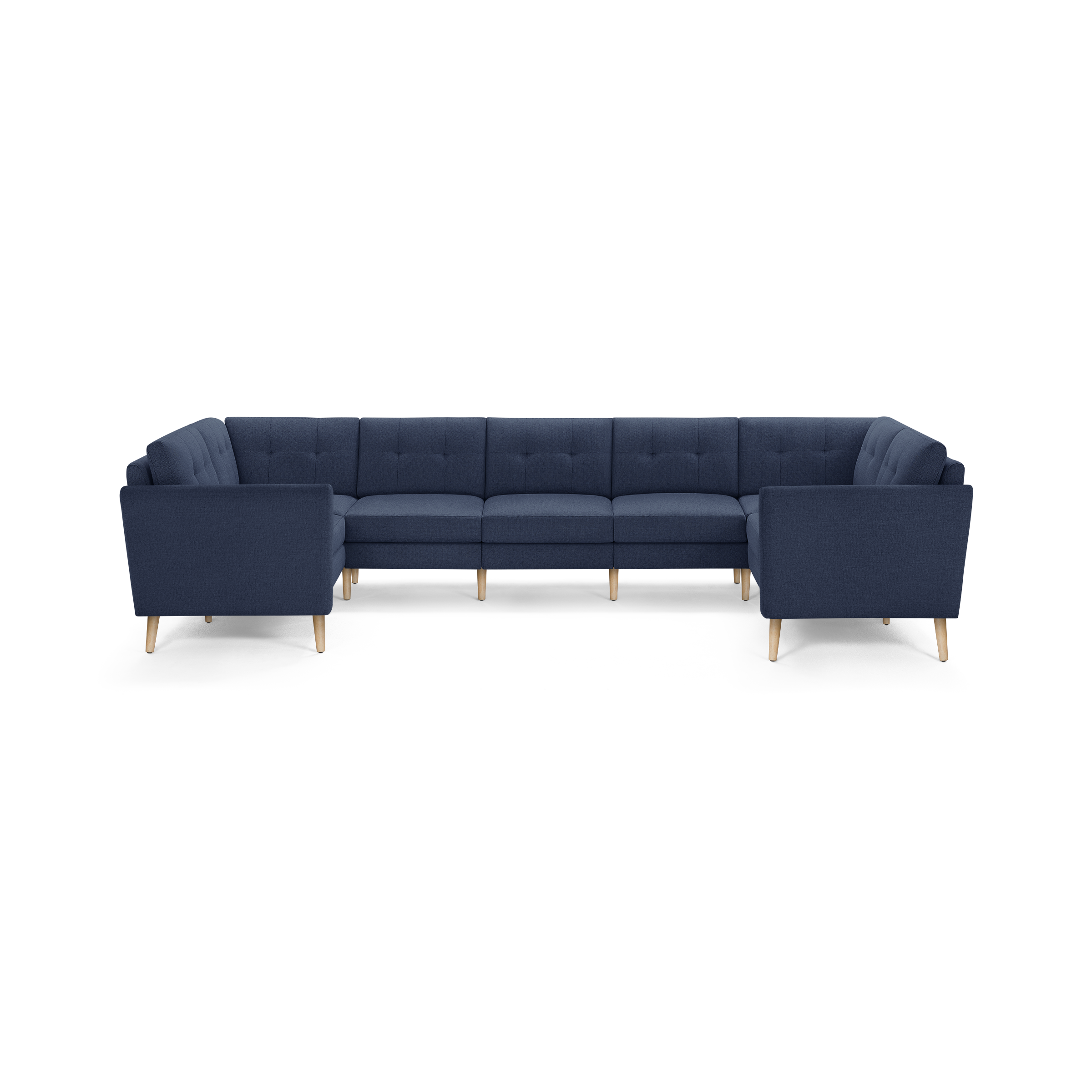 Large modern U-shaped sectional sofa in navy blue fabric with tufted back cushions and light wooden tapered legs.