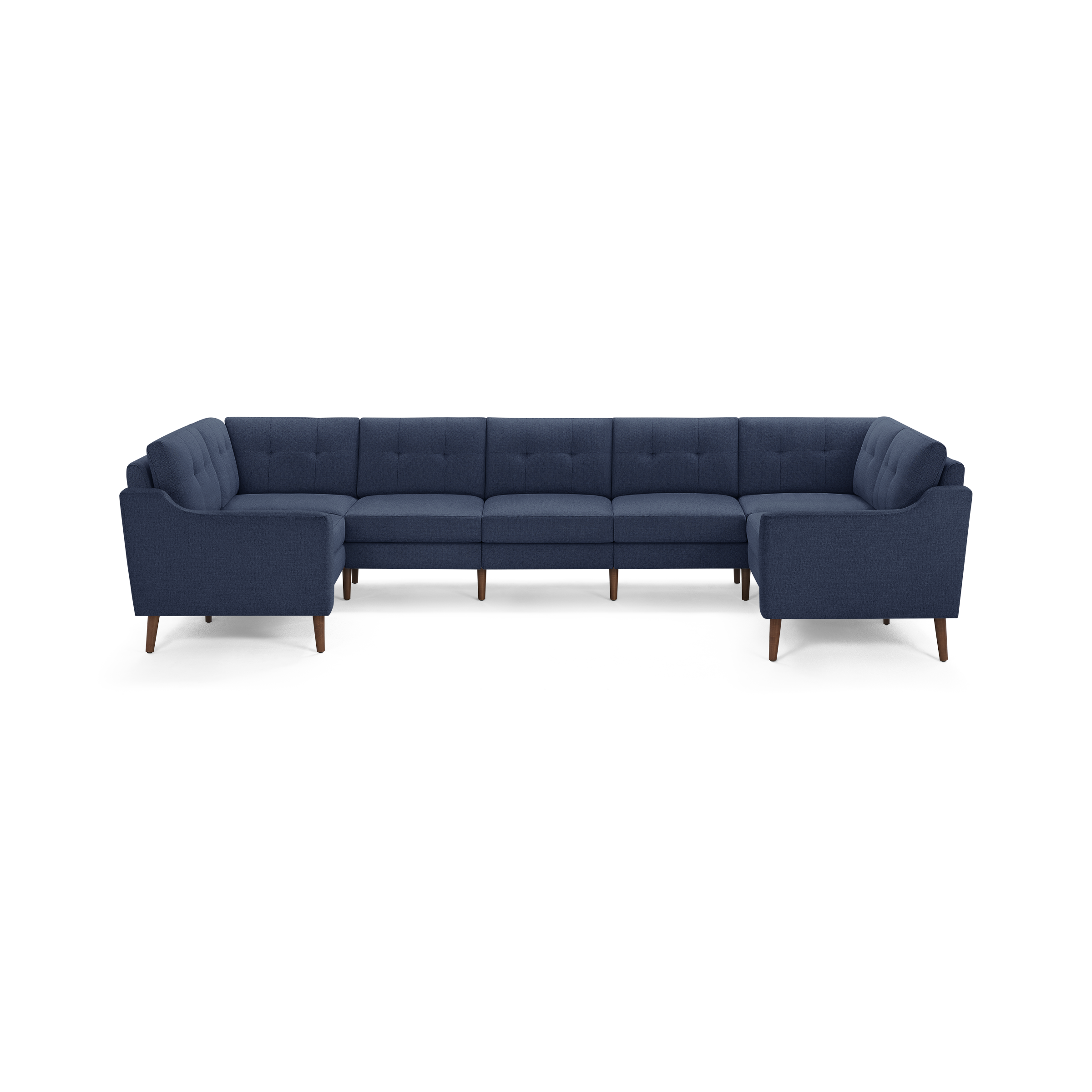 Large U-shaped sectional sofa in dark blue fabric with tufted back cushions and wooden tapered legs.