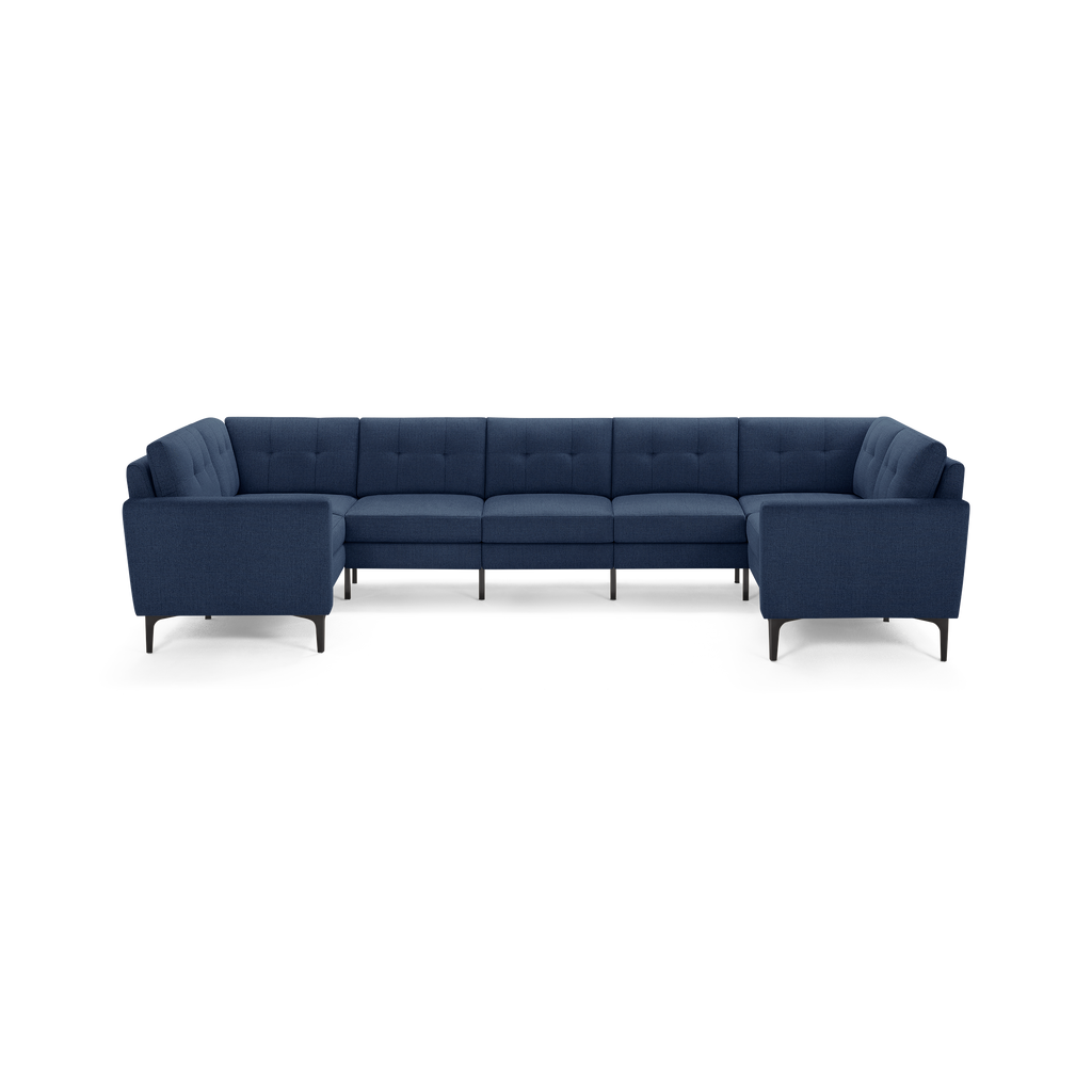 Modern navy blue L-shaped sectional sofa with tufted backrest, cushioned seats, and slim black legs.