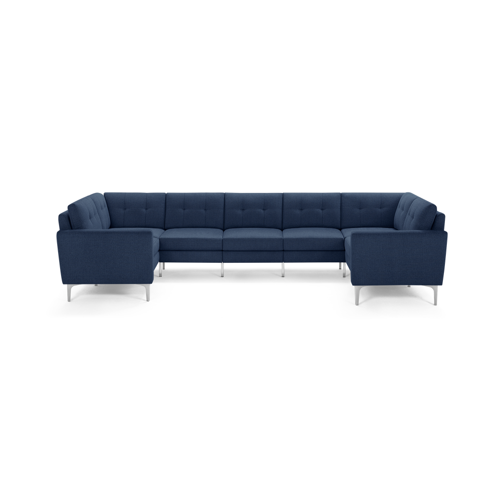 Large modern U-shaped sectional sofa with dark blue fabric upholstery and sleek metal legs, featuring tufted back cushions.