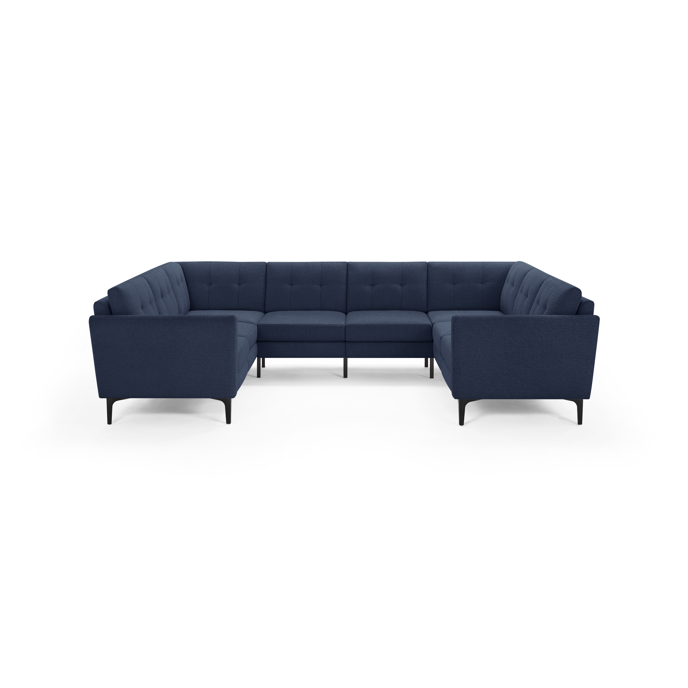 Large modern U-shaped sectional sofa upholstered in dark blue fabric with tufted back cushions and slim black legs.