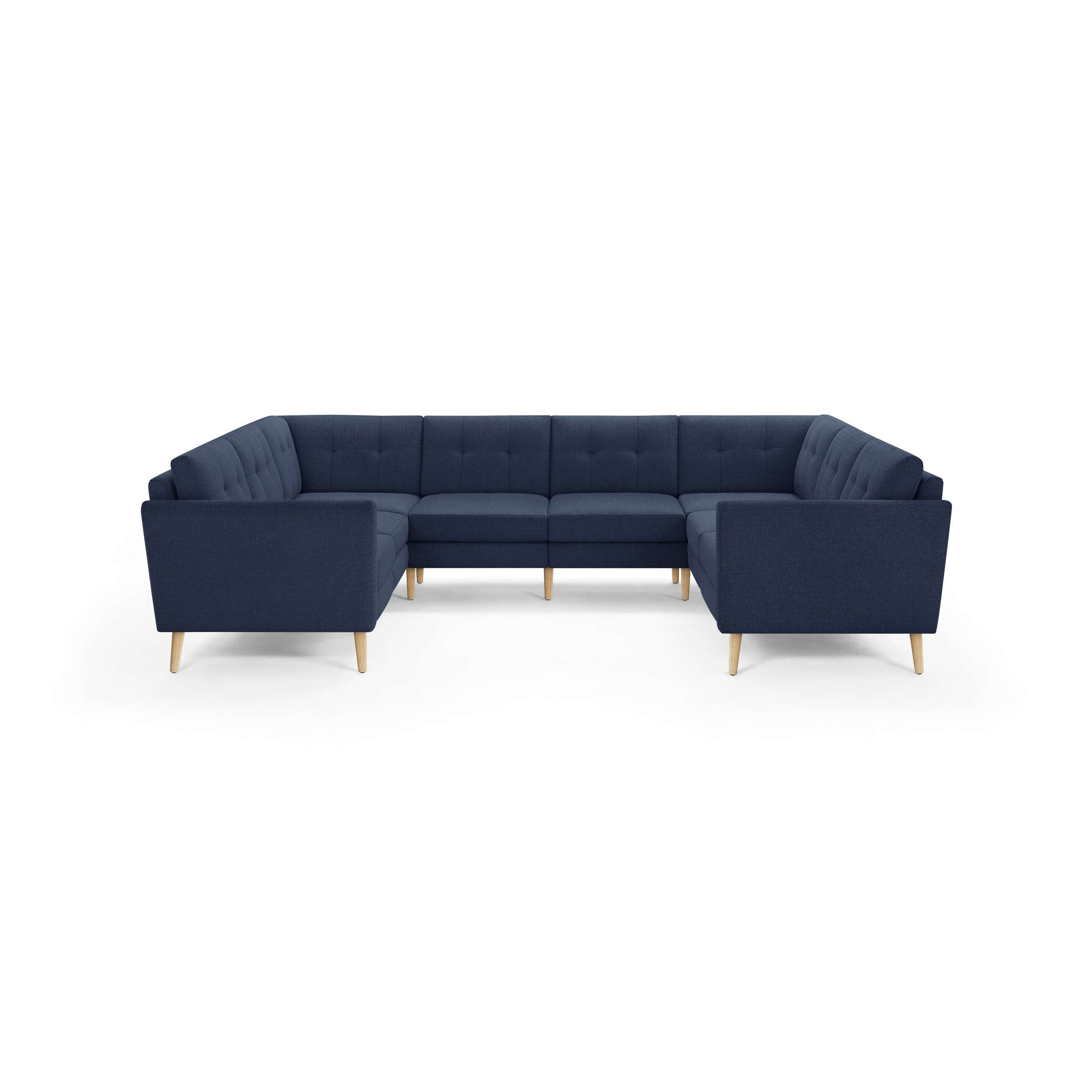 Large U-shaped sectional sofa with deep blue fabric upholstery, tufted back cushions, and light wooden tapered legs.