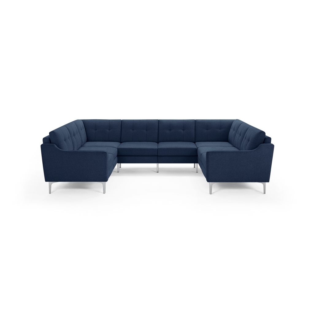 Modern navy blue U-shaped sectional sofa with tufted back cushions and slim silver metal legs.
