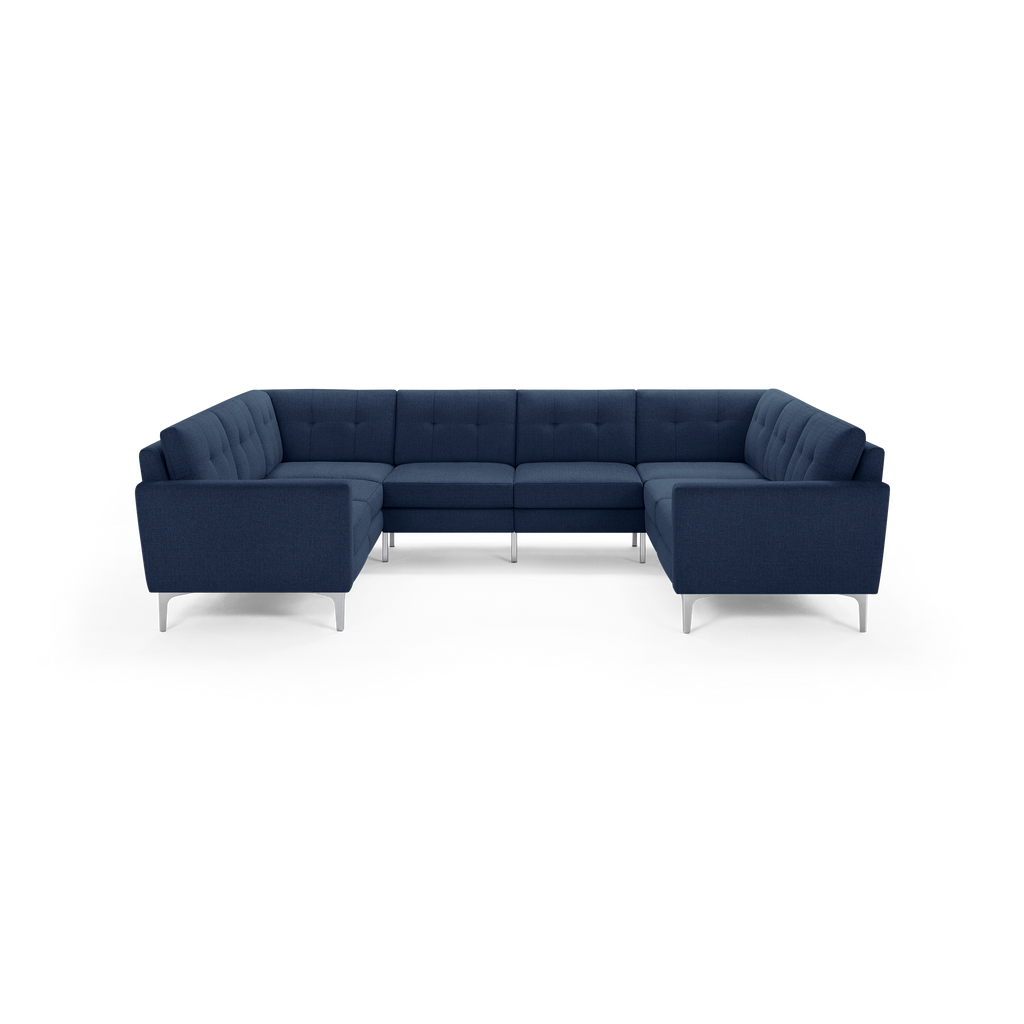 Dark blue fabric U-shaped sectional sofa with tufted cushions and sleek silver metal legs, designed for modern living spaces.