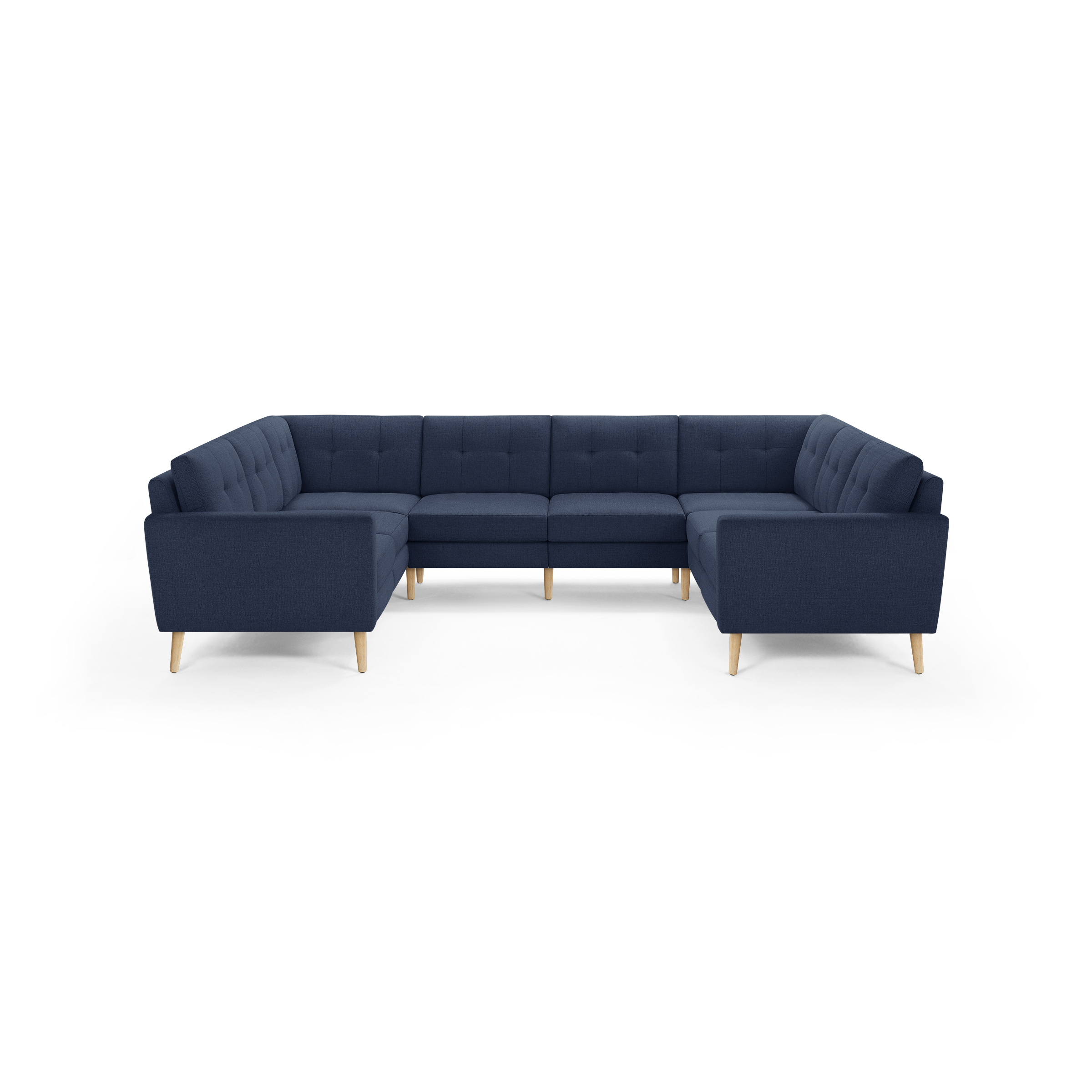 Large navy blue U-shaped sectional sofa with tufted cushions and light wooden legs, modern Scandinavian-style design.