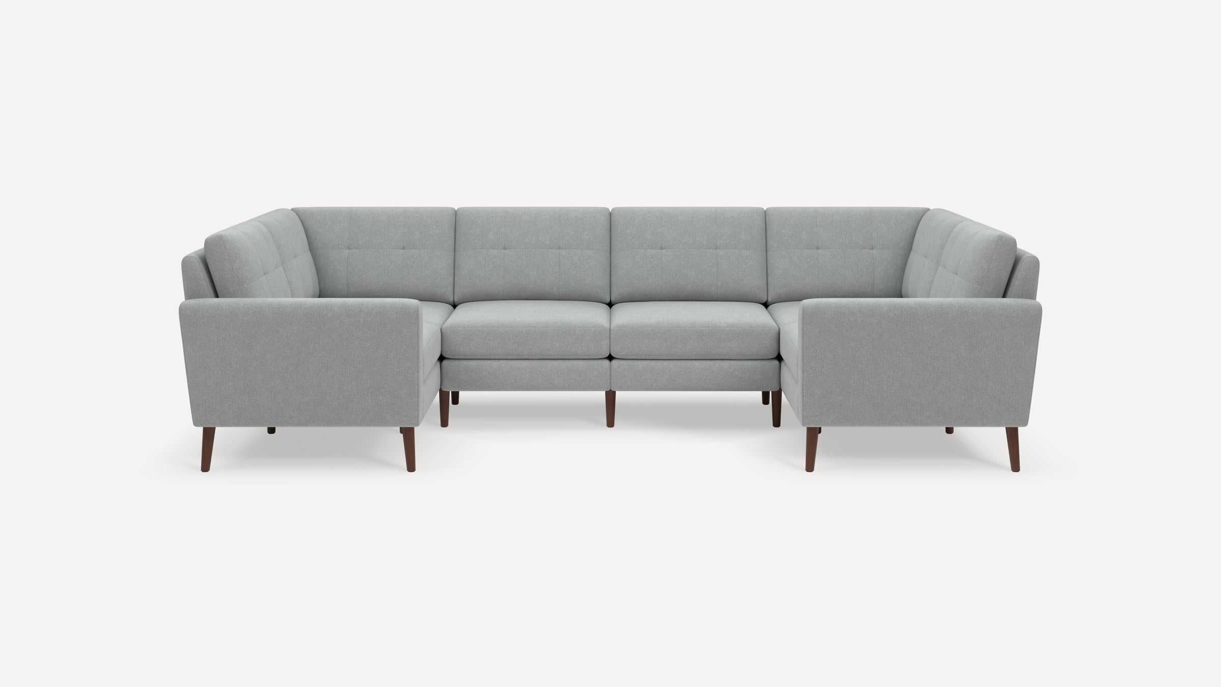 Light gray modern sectional sofa with tufted back cushions and wooden tapered legs, arranged in a U-shape.