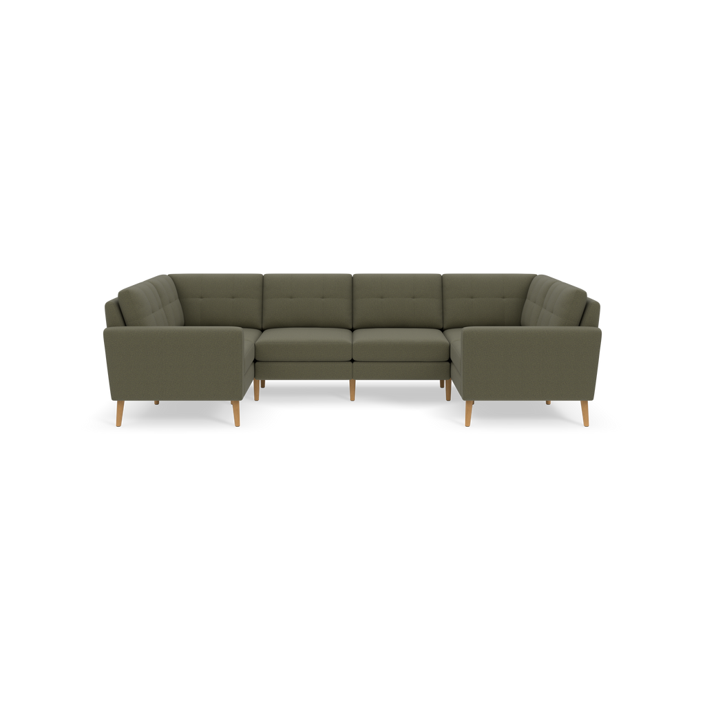 Large Moss green sectional sofa with tufted back cushions and wooden tapered legs, arranged in a U-shape against a black background.