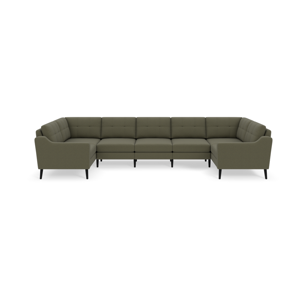 Large Moss green U-shaped sectional sofa with tufted back cushions and slender black legs against black background.