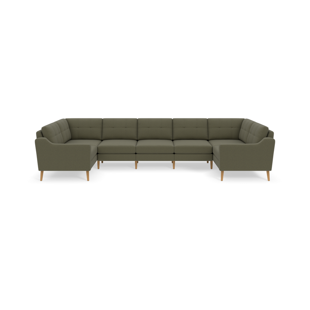 Large U-shaped sectional sofa in muted Moss green fabric with tufted back cushions and light wooden legs.