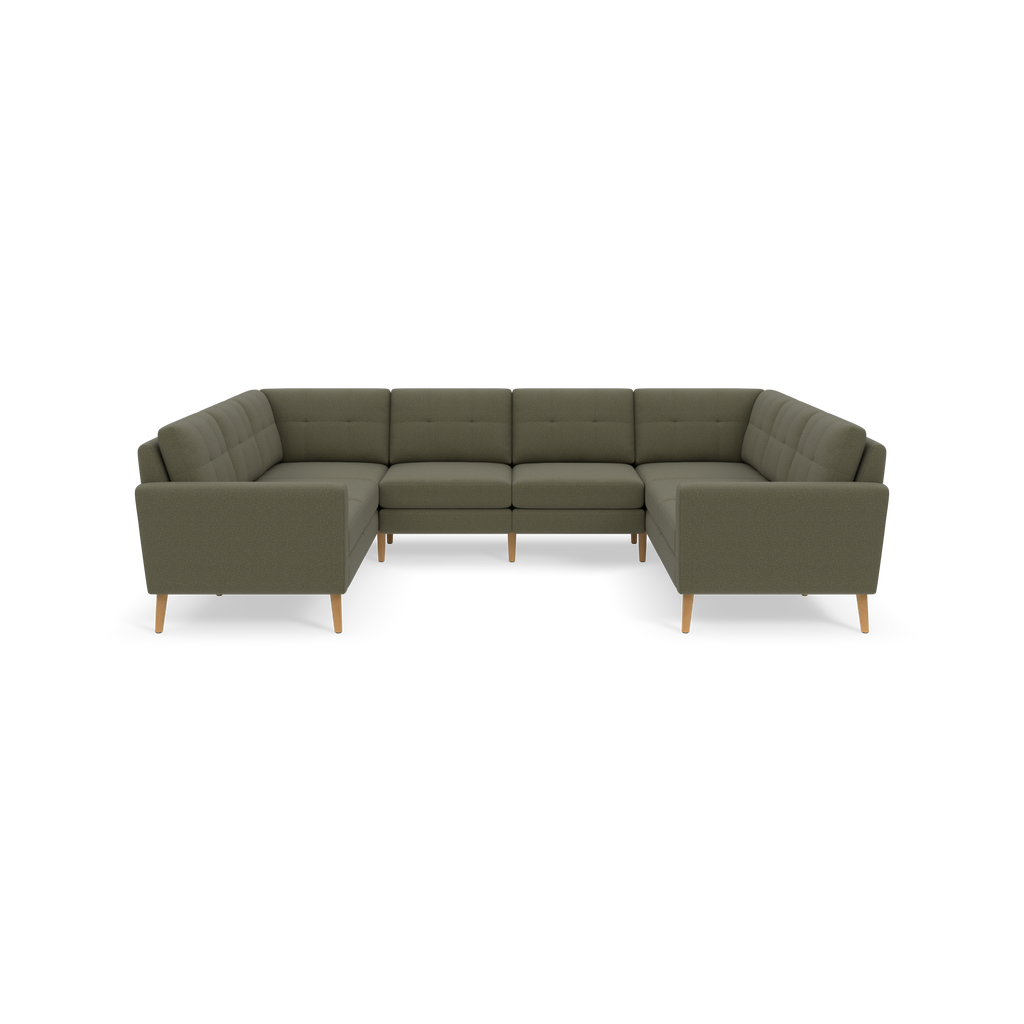 Large Moss green U-shaped sectional sofa with tufted cushions and light wooden legs against black background.
