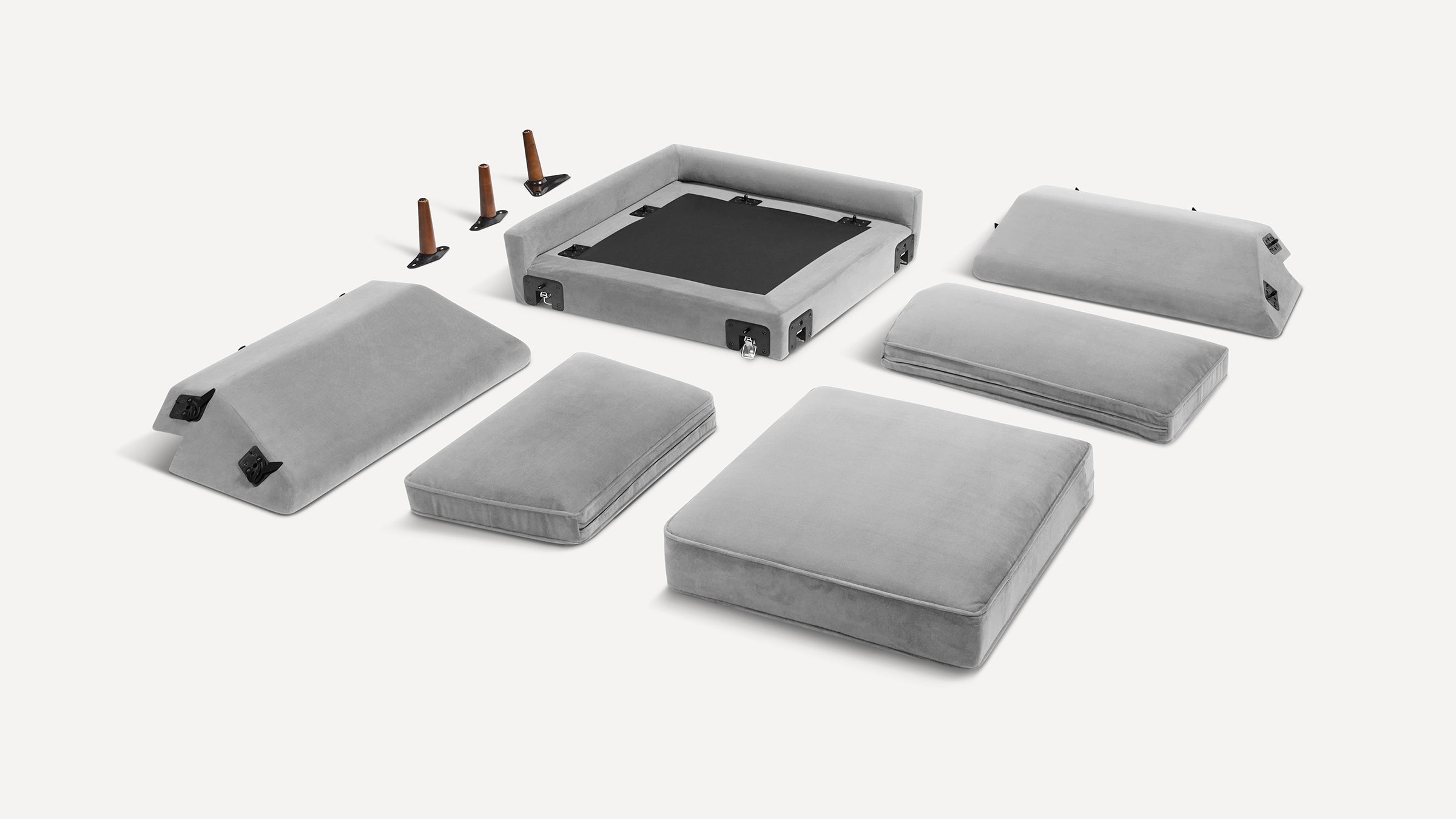 Light gray sectional sofa cushions and frame pieces laid out separately with four wooden legs on a white background.