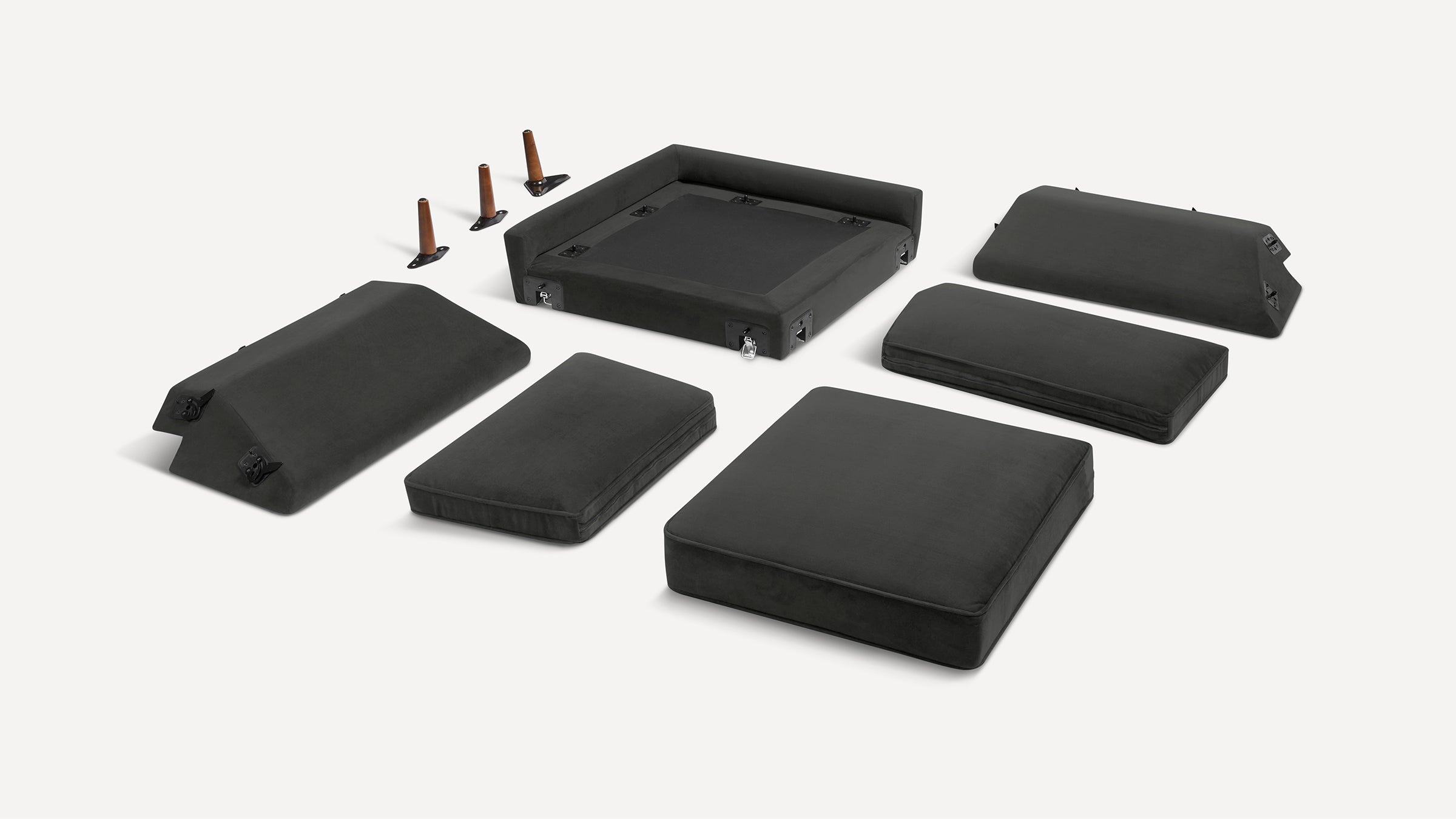 Black modular sofa pieces and wooden legs displayed separately on a white background for assembly.