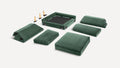 Disassembled green velvet modular sofa with cushions, backrests, and wooden legs laid out on a white background.