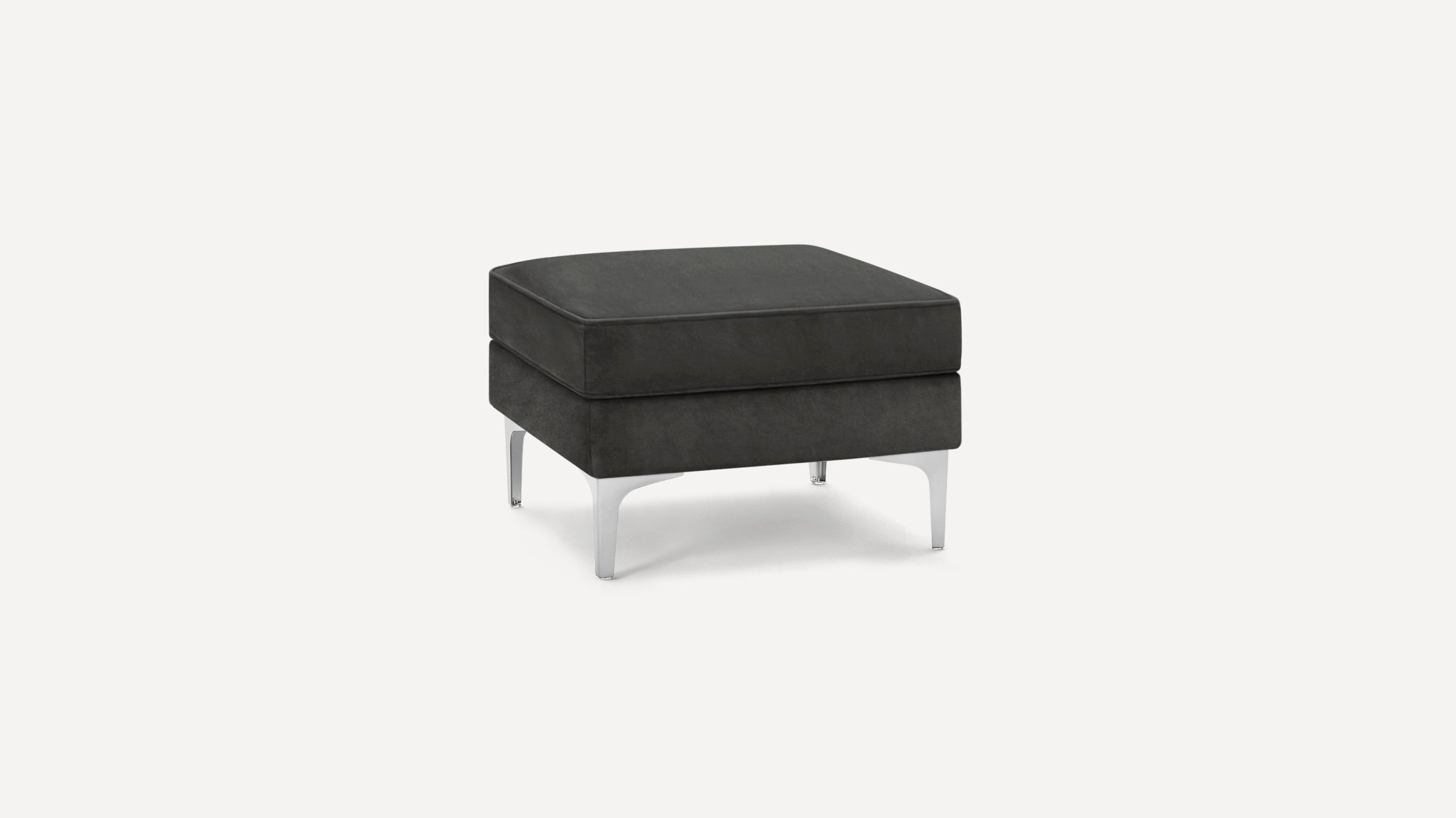 Square black upholstered ottoman with a cushioned top and sleek silver metal legs on a white background.