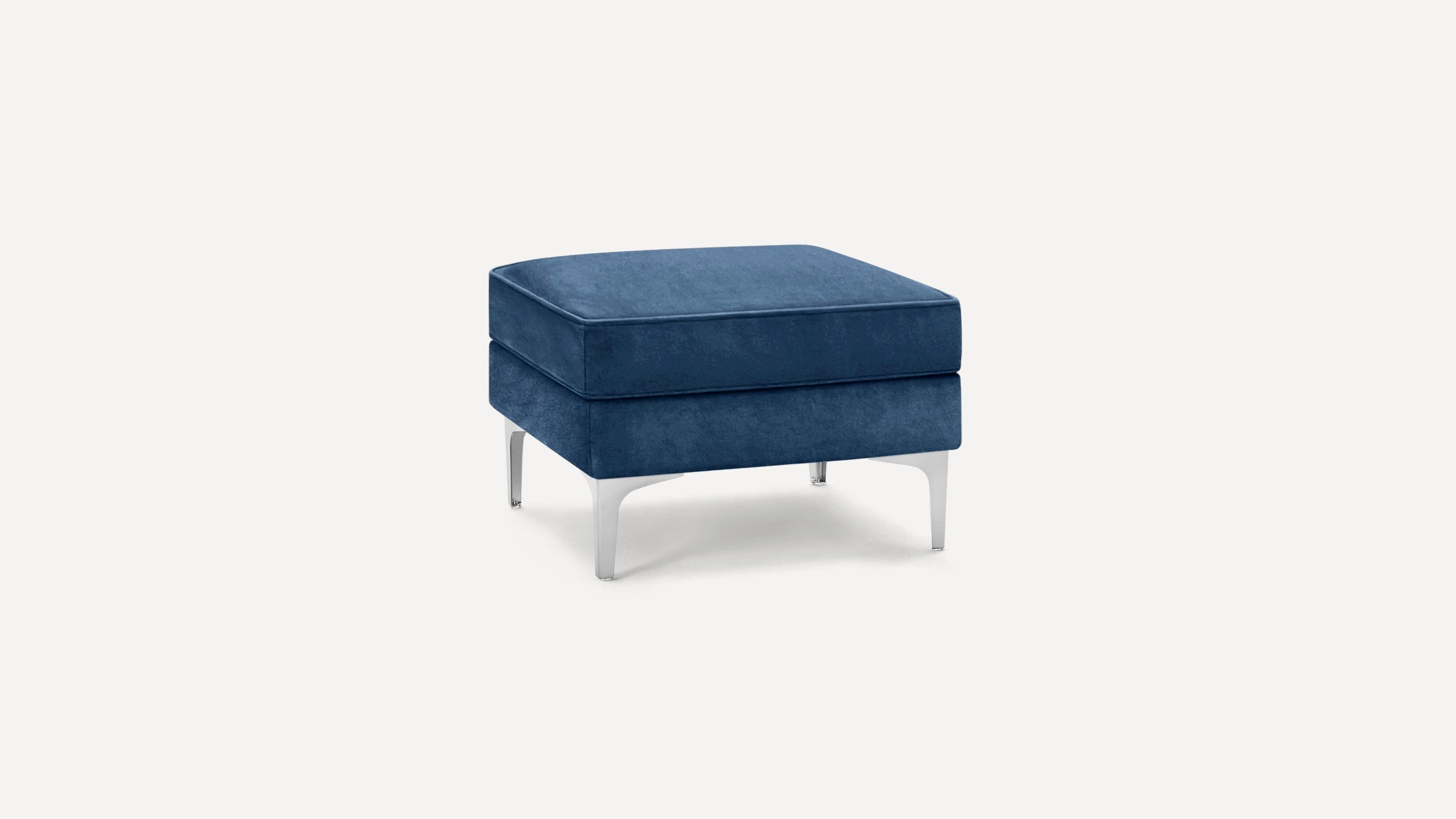 Square navy blue upholstered ottoman with sleek silver metal legs on a white background.