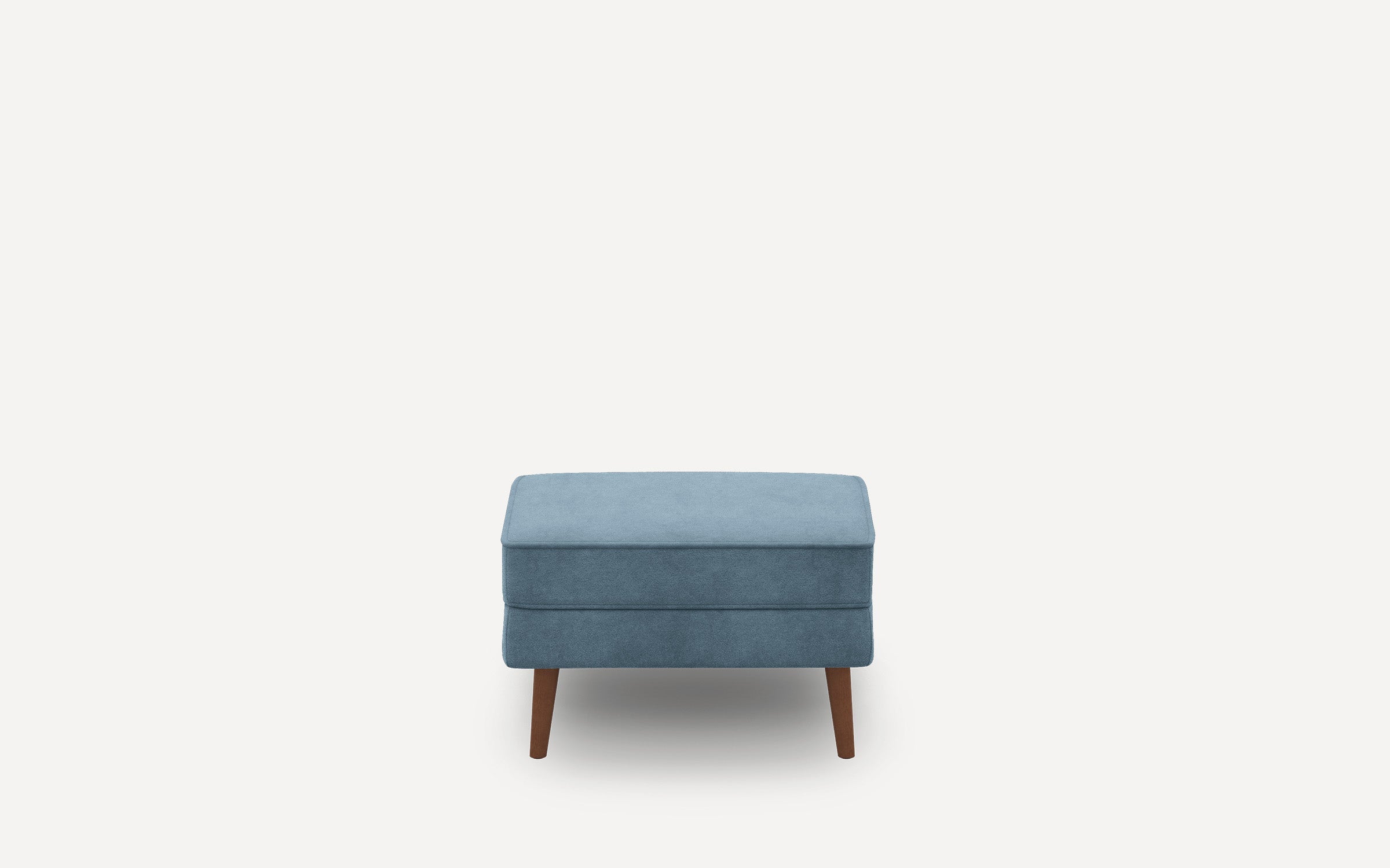 Small rectangular blue ottoman with soft fabric upholstery and four wooden tapered legs, shown against a white background.