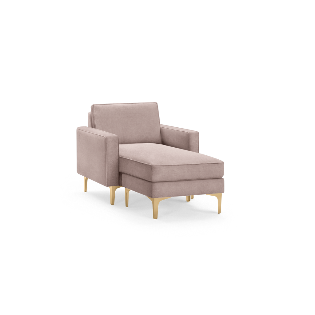 modern light pink upholstered chaise lounge chair with gold legs and matching ottoman, featuring a sleek, modern design