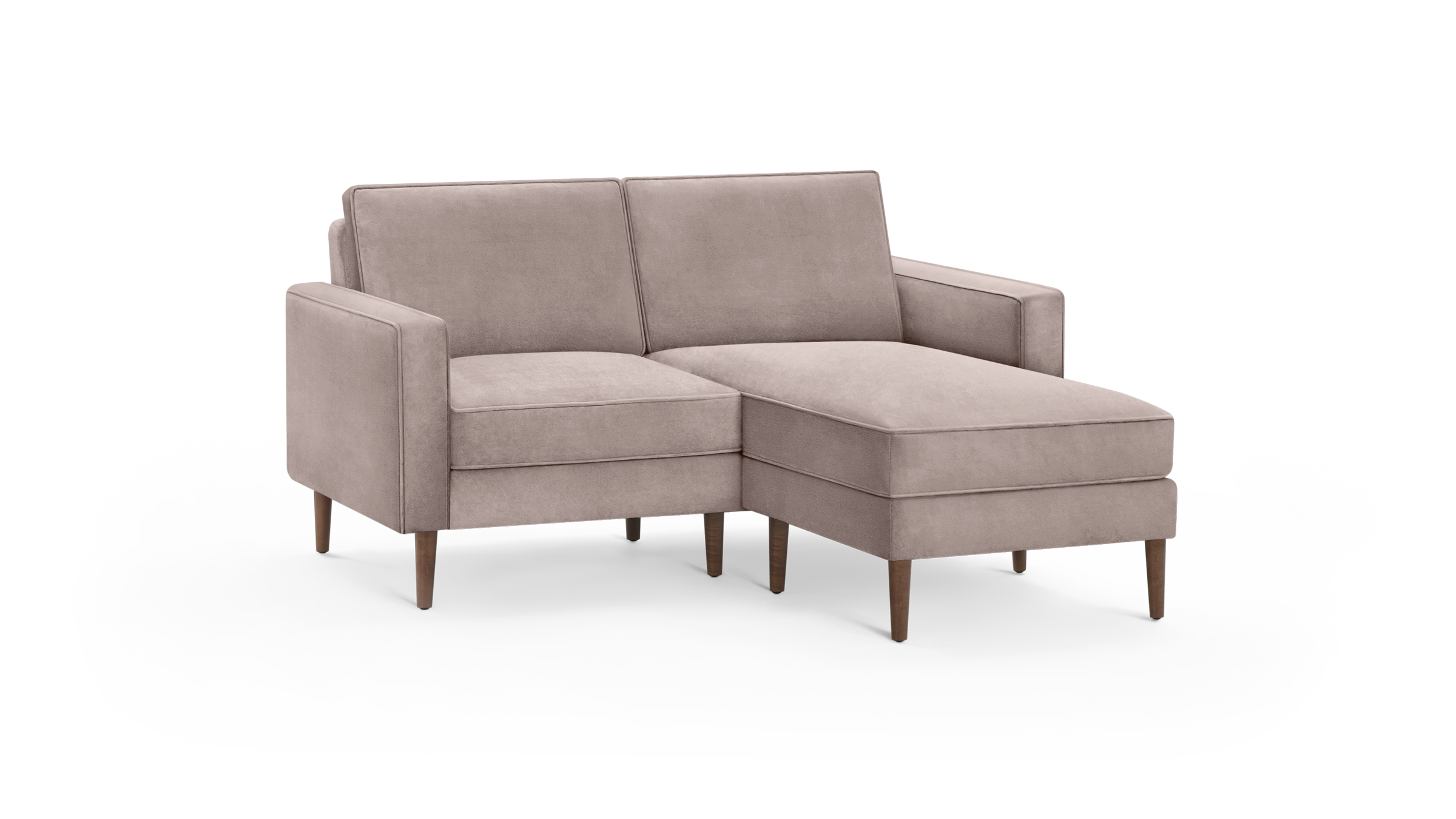modern light pink velvet sectional sofa with wooden legs and matching ottoman, featuring a clean, minimalist design