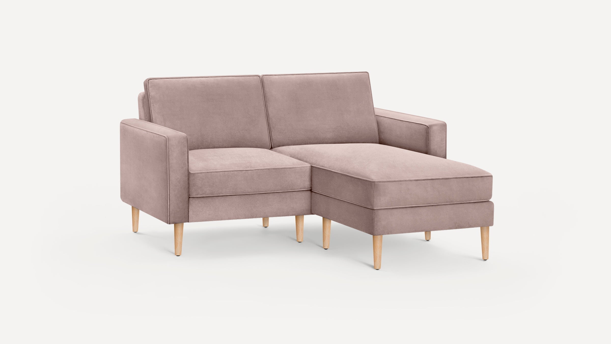 Light mauve fabric sectional sofa with wooden tapered legs, featuring a right-side chaise and clean, modern lines.