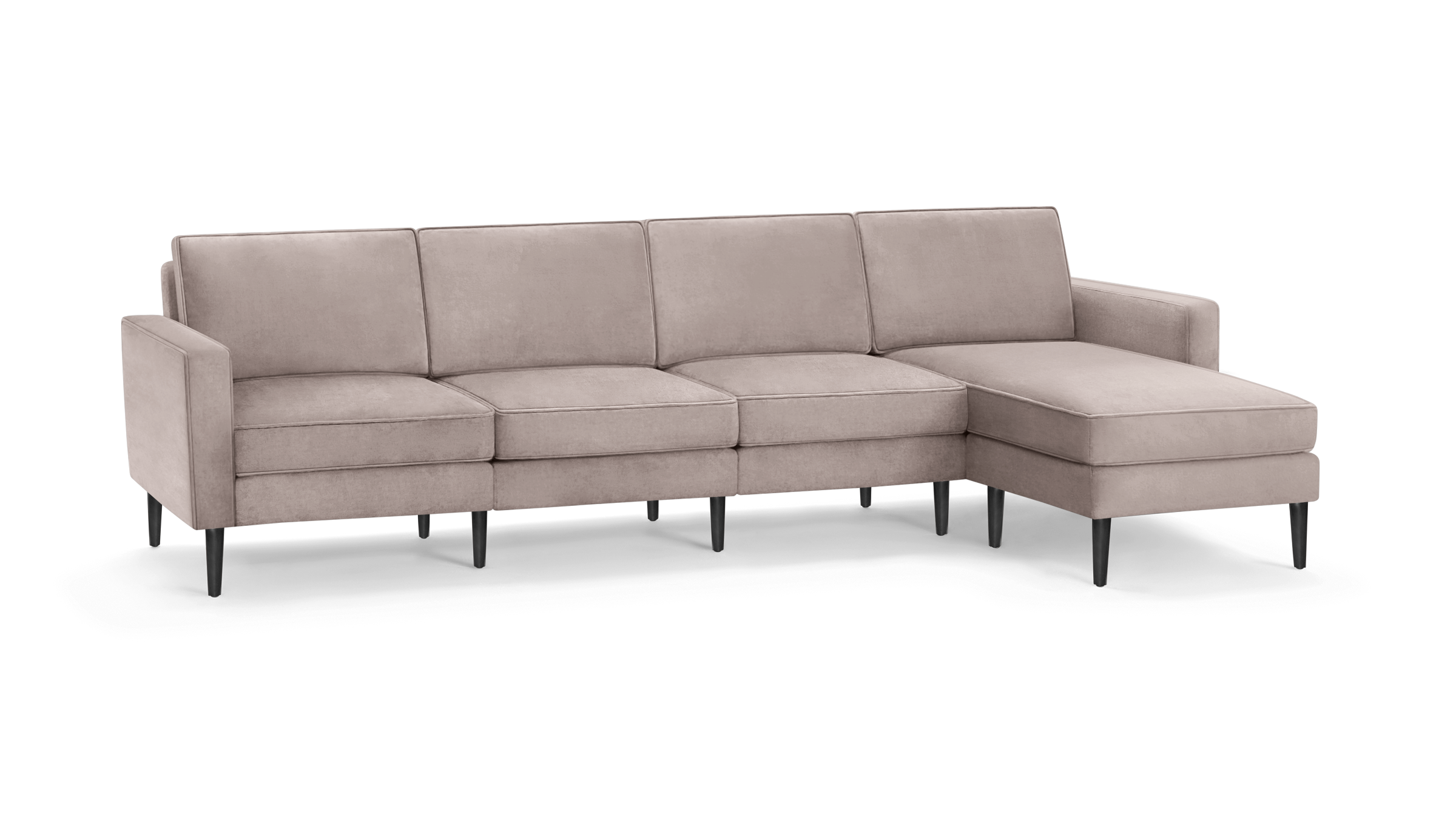 modern light pink sectional sofa with black legs and clean lines on the back, featuring a chaise lounge and matching ottoman