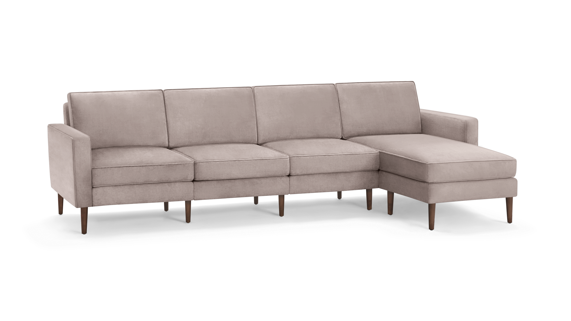 modern light pink sectional sofa with wooden legs and clean lines on the back, featuring a chaise lounge and matching ottoman