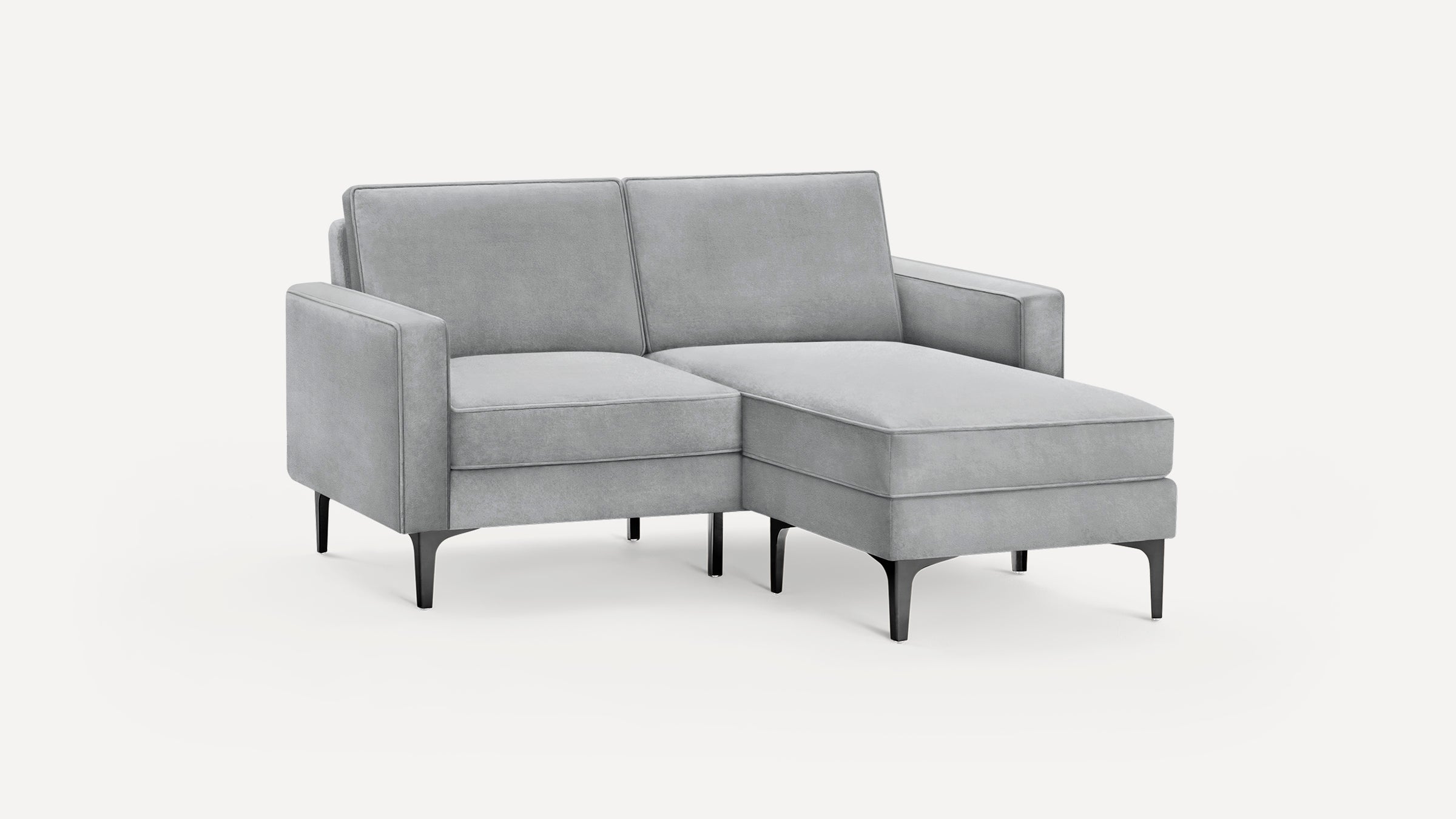 Light gray modern chaise lounge sofa with plush cushions, square arms, and black metal legs on a white background.