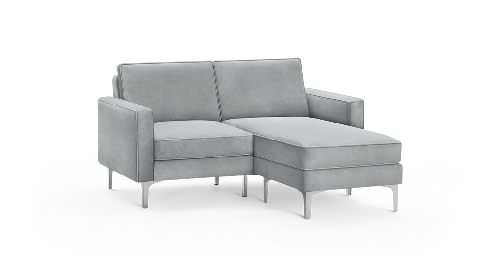 modern light gray fabric sectional sofa with matching ottoman, featuring tapered backrests, and matching cushions, featuring a matching ottoman