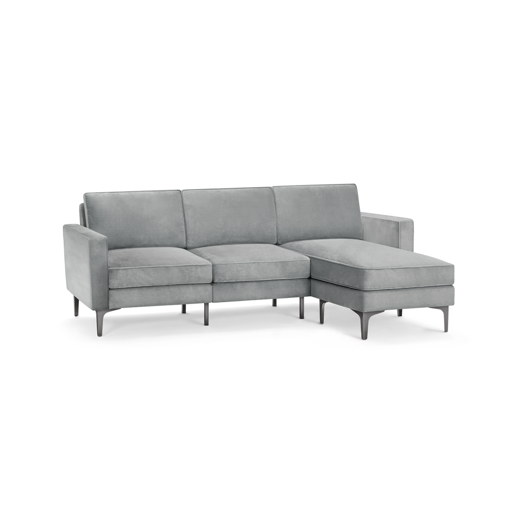 modern l - shaped sectional sofa with tufted back cushions and tapered legs in light gray fabric, featuring a sleek design and sleek lines