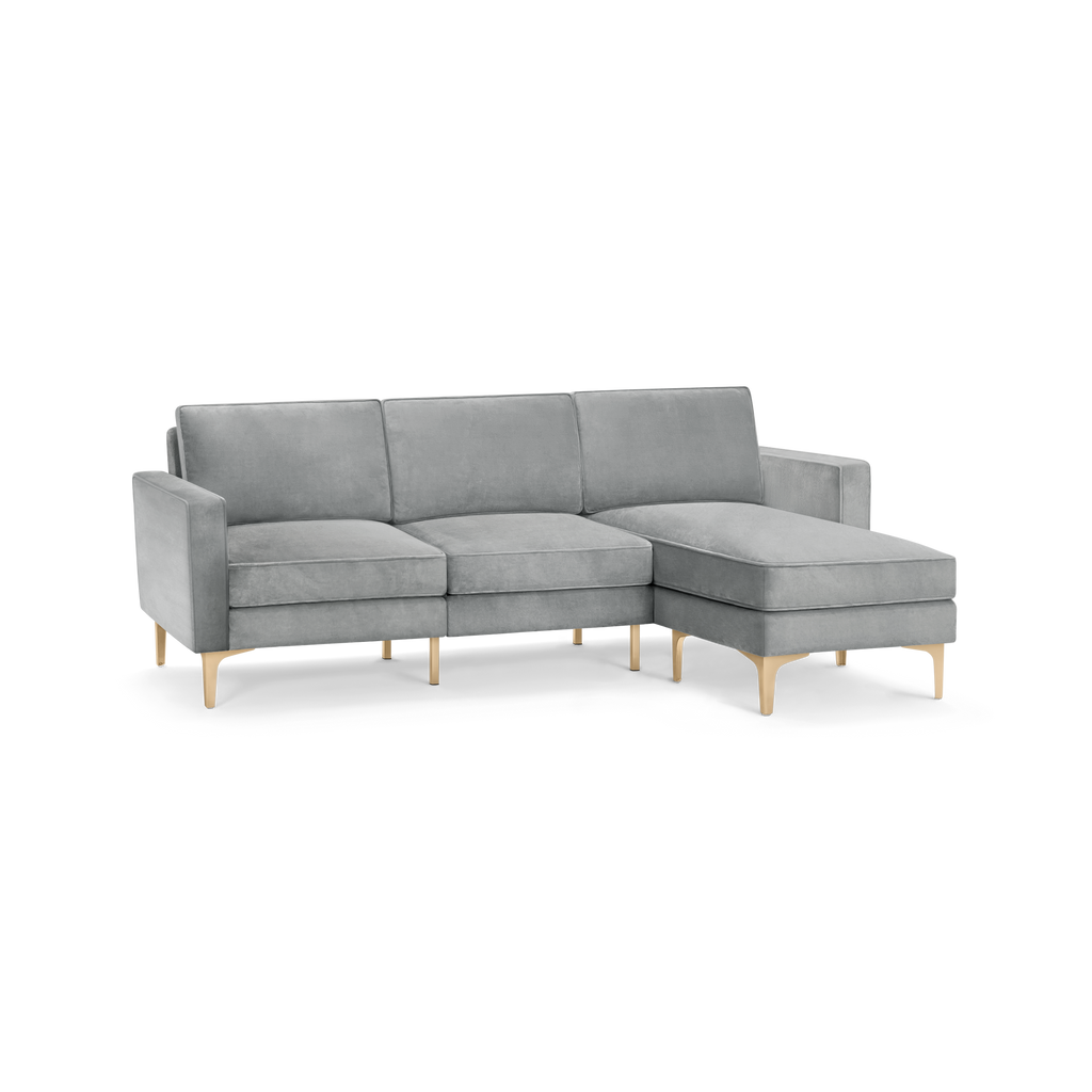 modern l - shaped sectional sofa with light gray fabric upholstery, tapered wooden legs, and tapered cushioned cushions, designed