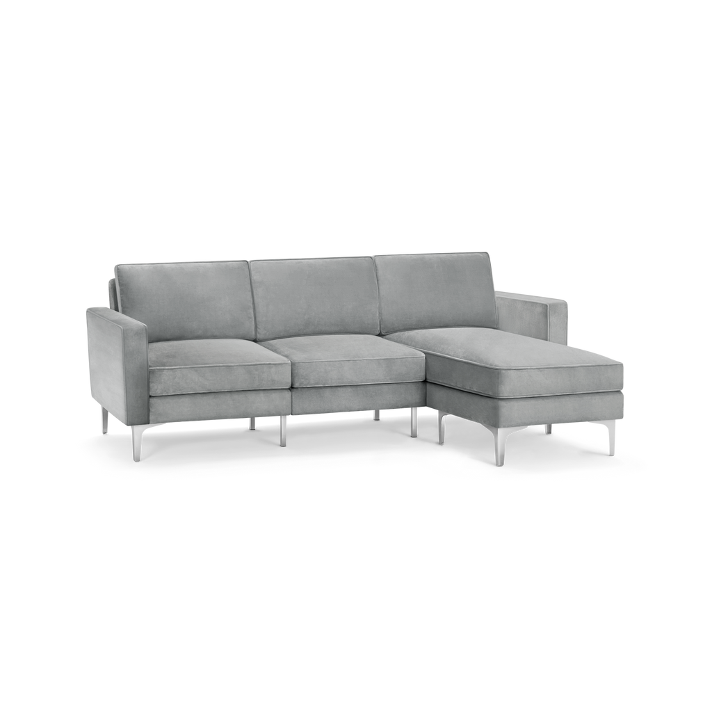 modern l - shaped sectional sofa with light gray fabric upholstery, tapered armrests, and tapered backrests, featuring