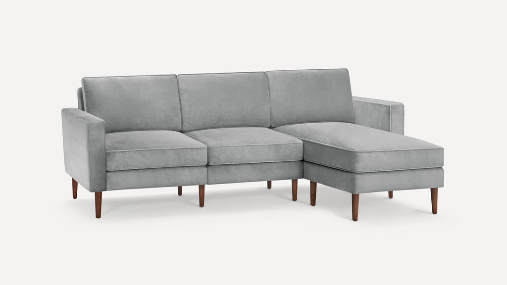 Modern gray velvet sectional sofa with clean lines, wooden tapered legs, and a right-side chaise lounge.