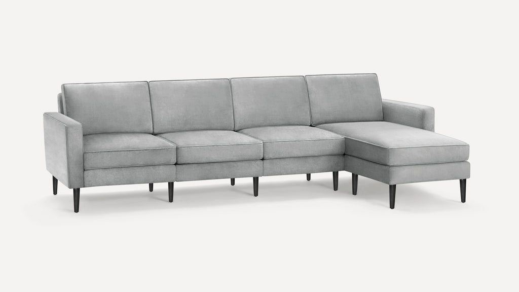 Modern light gray sectional sofa with clean lines, upholstered cushions, and black tapered wooden legs on a white background.