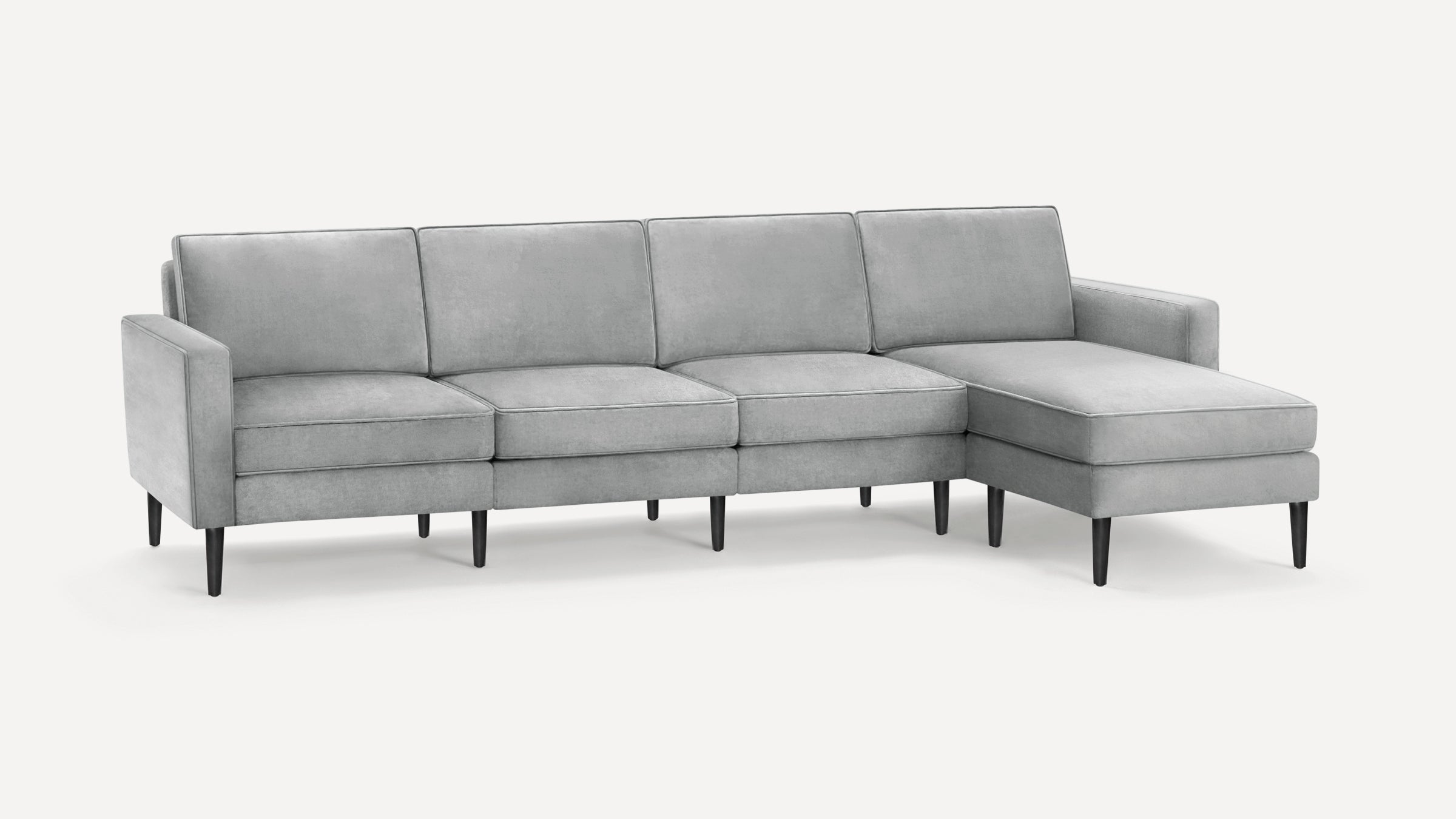 Modern light gray sectional sofa with clean lines, upholstered cushions, and black tapered wooden legs on a white background.