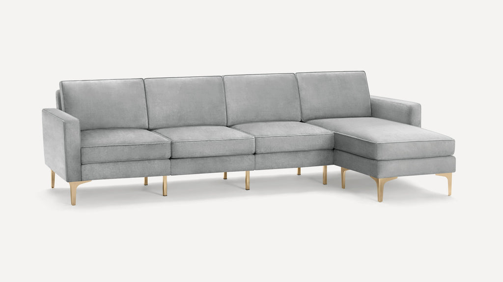 Light gray modern sectional sofa with sleek gold metal legs and a chaise lounge on the right side.