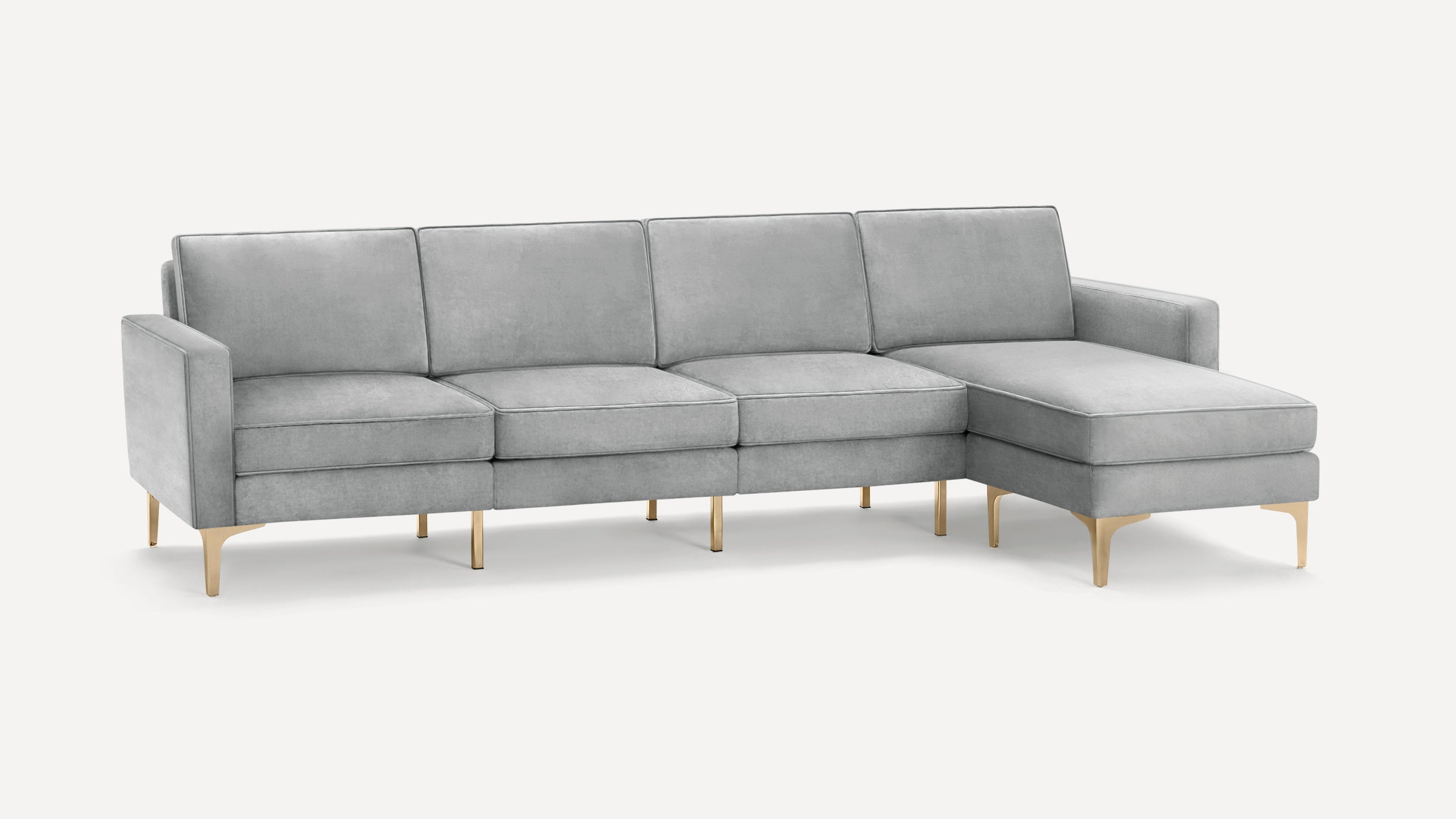 Light gray modern sectional sofa with sleek gold metal legs and a chaise lounge on the right side.