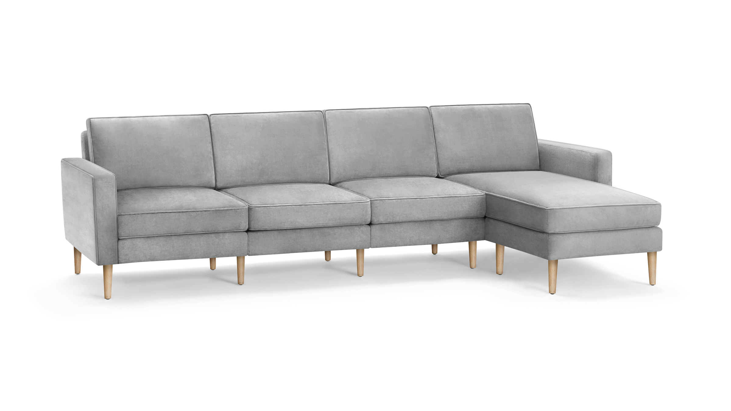 light gray modern sectional sofa with wooden legs and matching ottoman, featuring a clean, minimal design