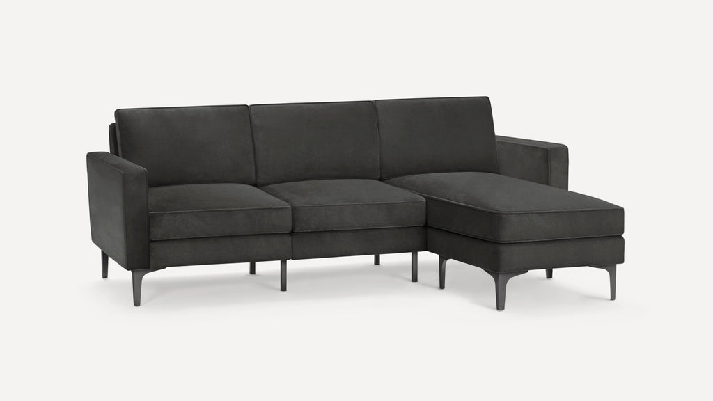 Modern dark gray sectional sofa with clean lines, three seat cushions, straight arms, and metal tapered legs.