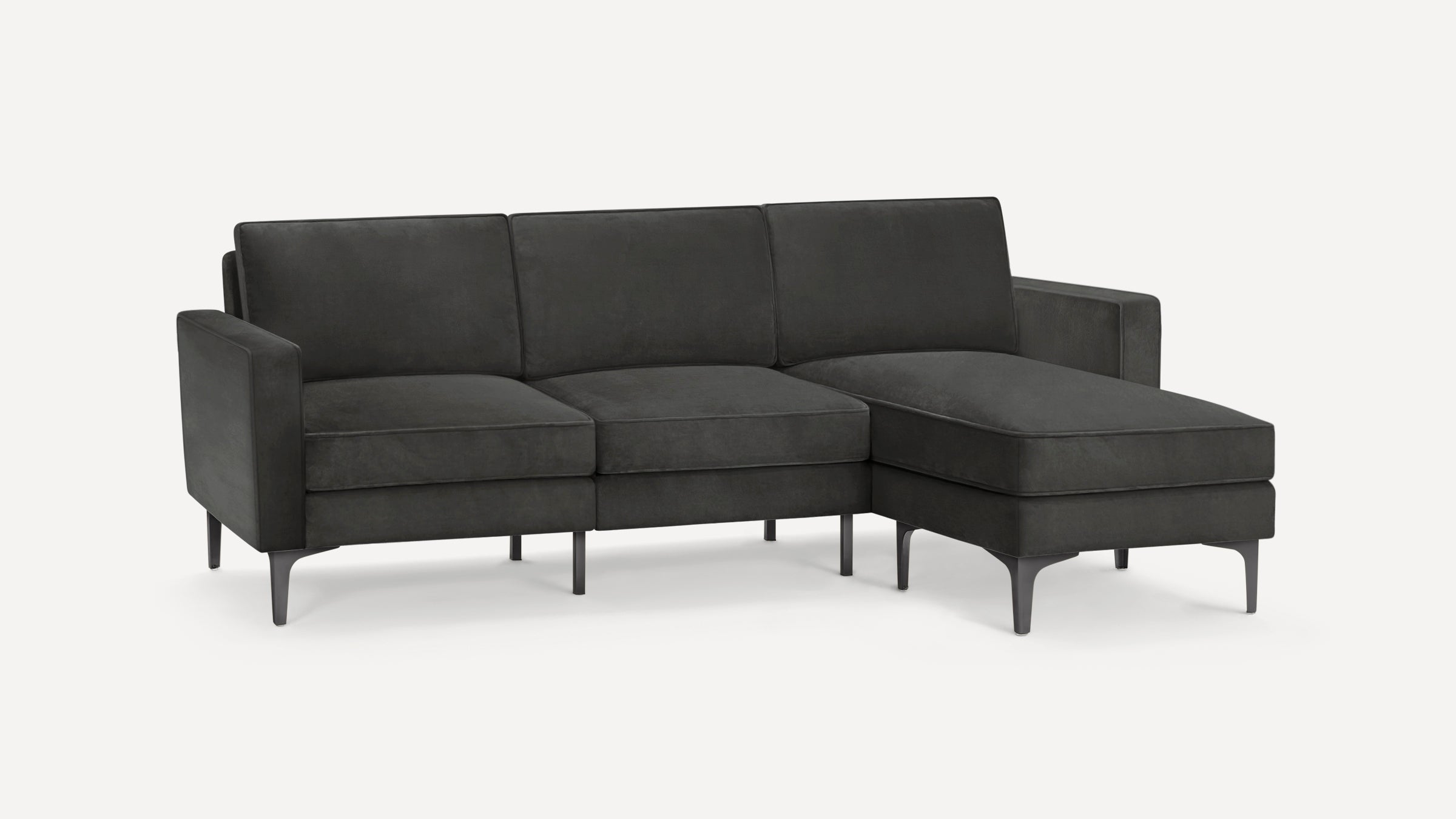 Modern dark gray sectional sofa with clean lines, three seat cushions, straight arms, and metal tapered legs.
