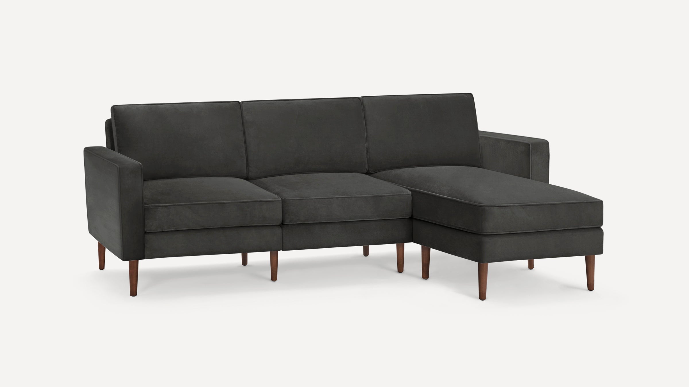Dark gray modern sectional sofa with clean lines, tufted cushions, wooden tapered legs, and right-side chaise lounge.