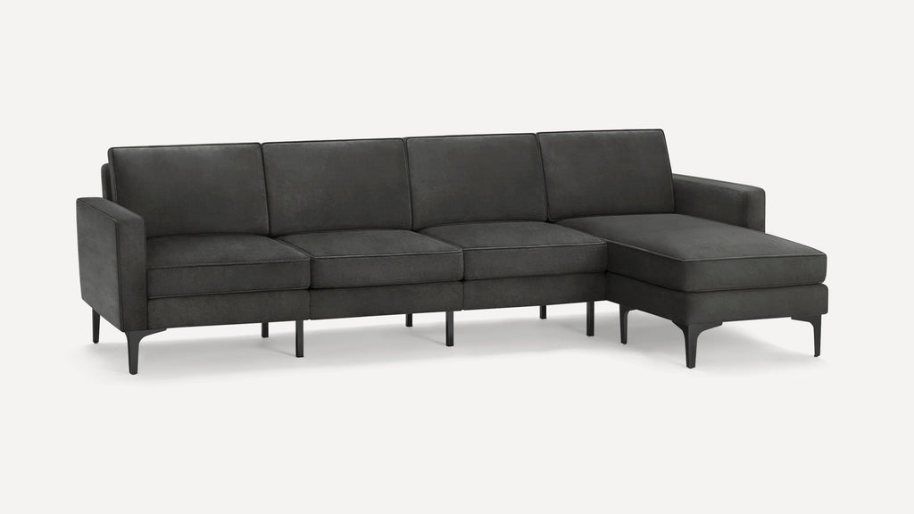 Modern dark gray sectional sofa with chaise, slim armrests, and elevated black metal legs for a sleek look.