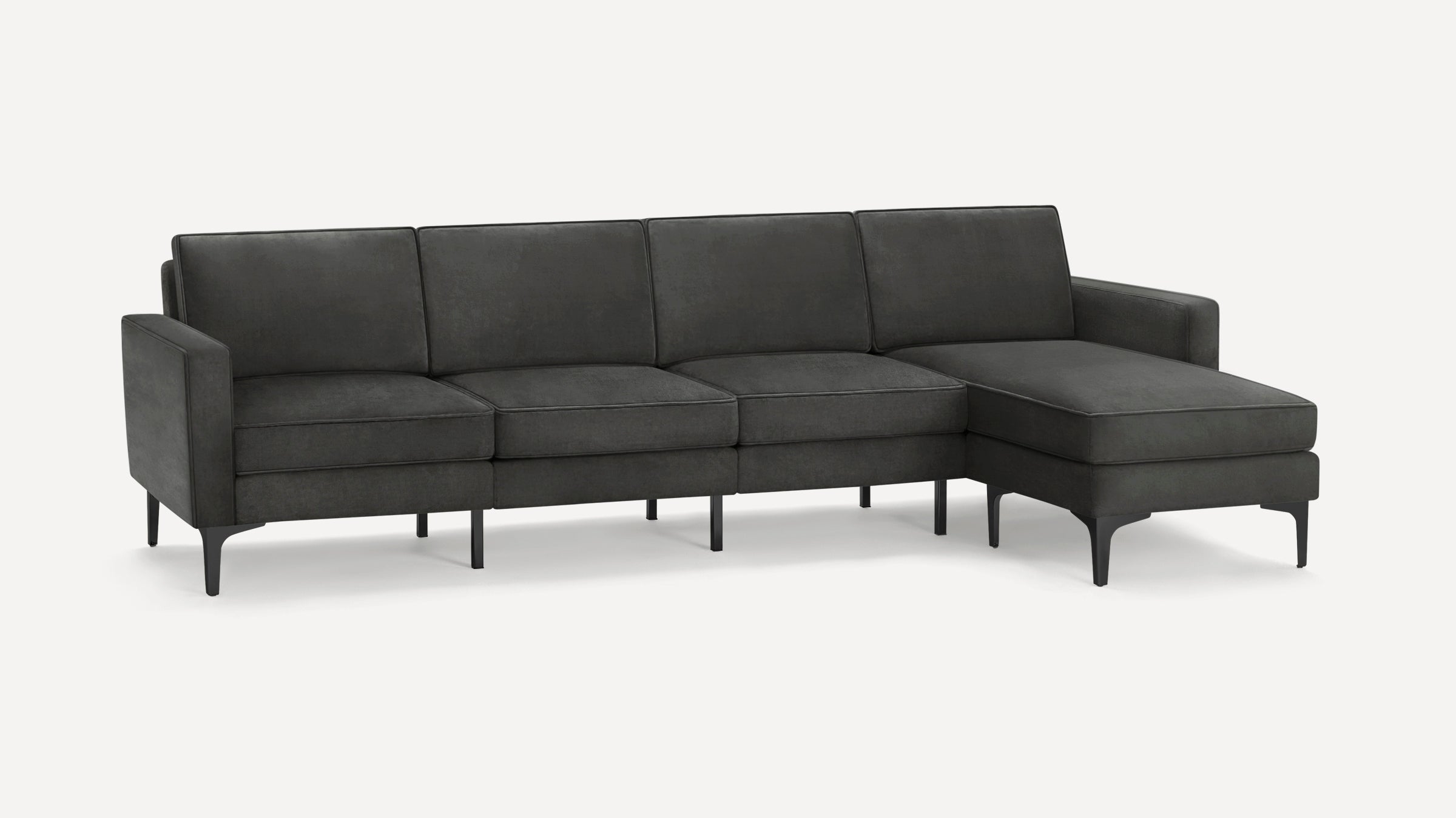 Modern dark gray sectional sofa with chaise, slim armrests, and elevated black metal legs for a sleek look.