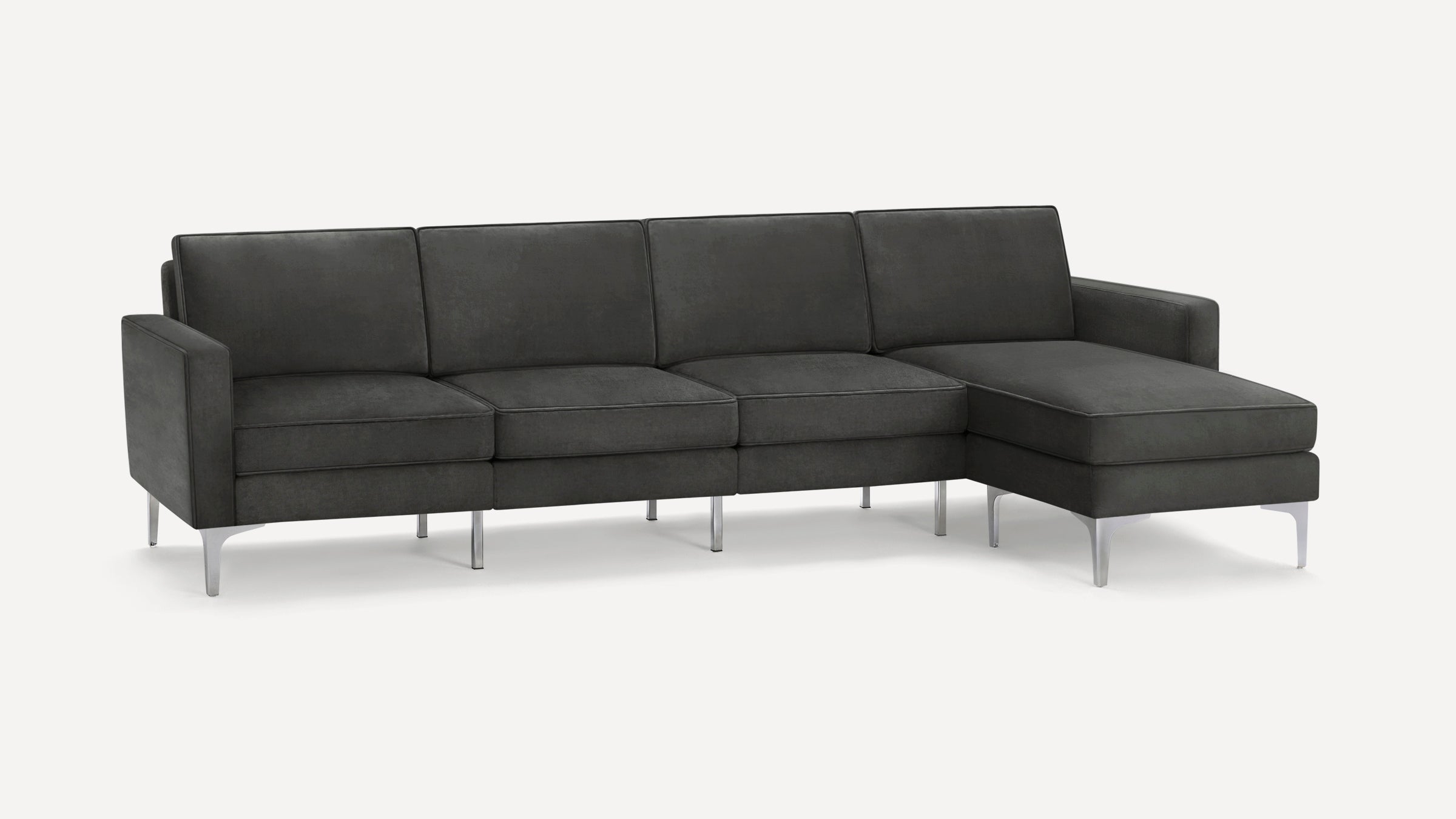 Dark gray sectional sofa with clean lines, metal legs, and chaise lounge on the right side, modern and minimalist design.