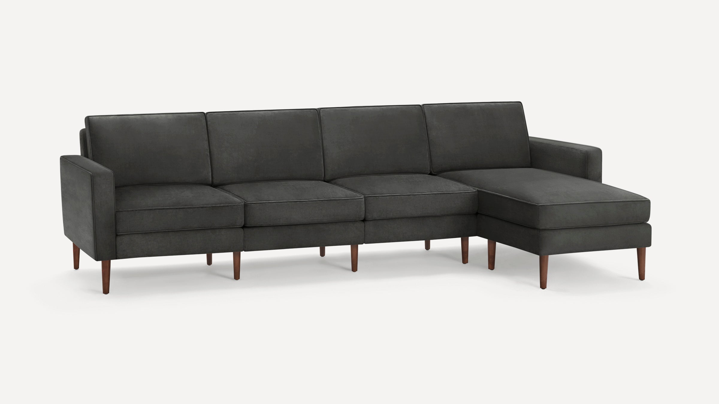 Dark gray modern sectional sofa with clean lines, straight arms, tapered wooden legs, and a chaise lounge on the right side.