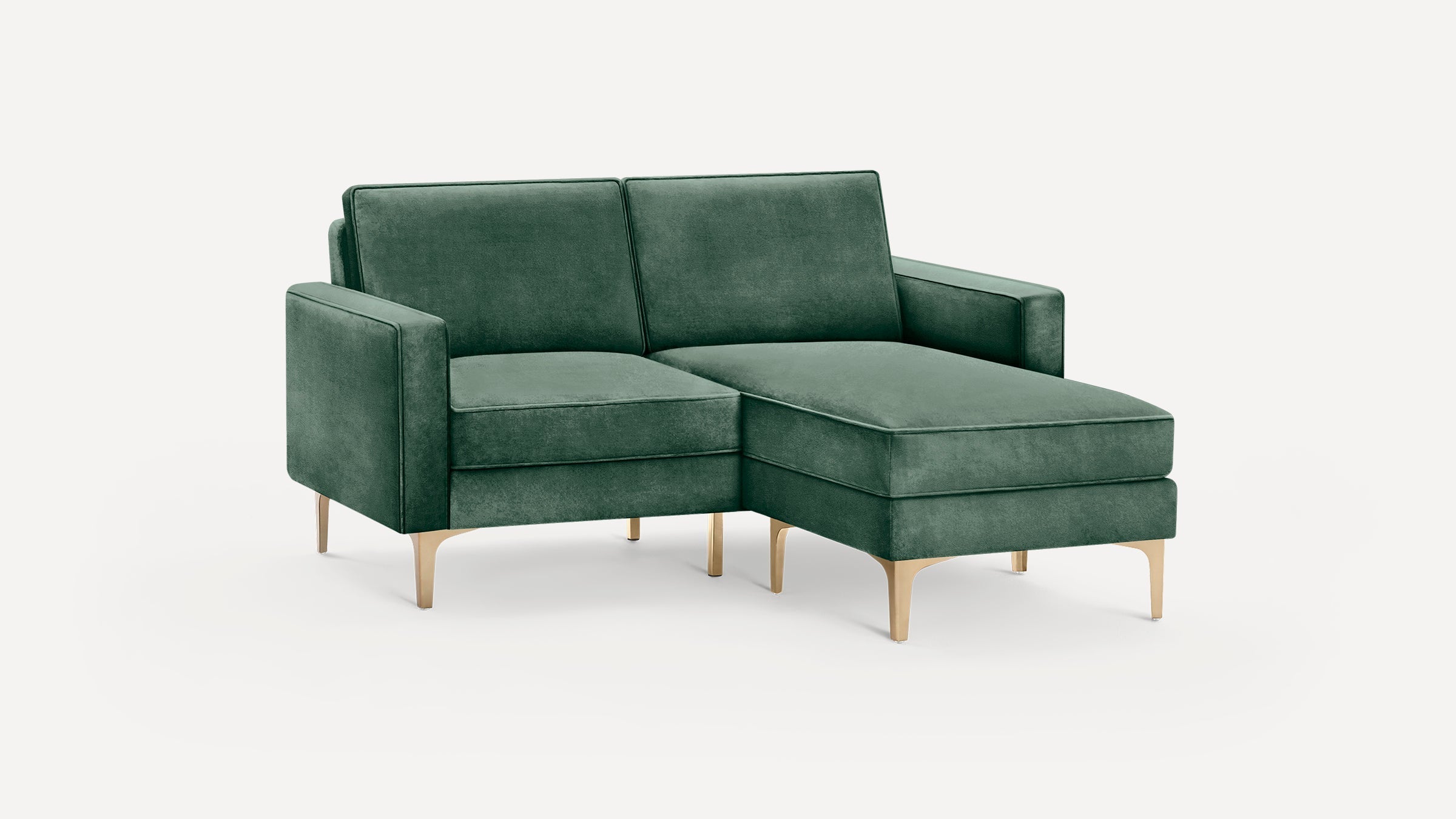Modern dark green velvet sectional sofa with chaise lounge and gold metal legs on white background.