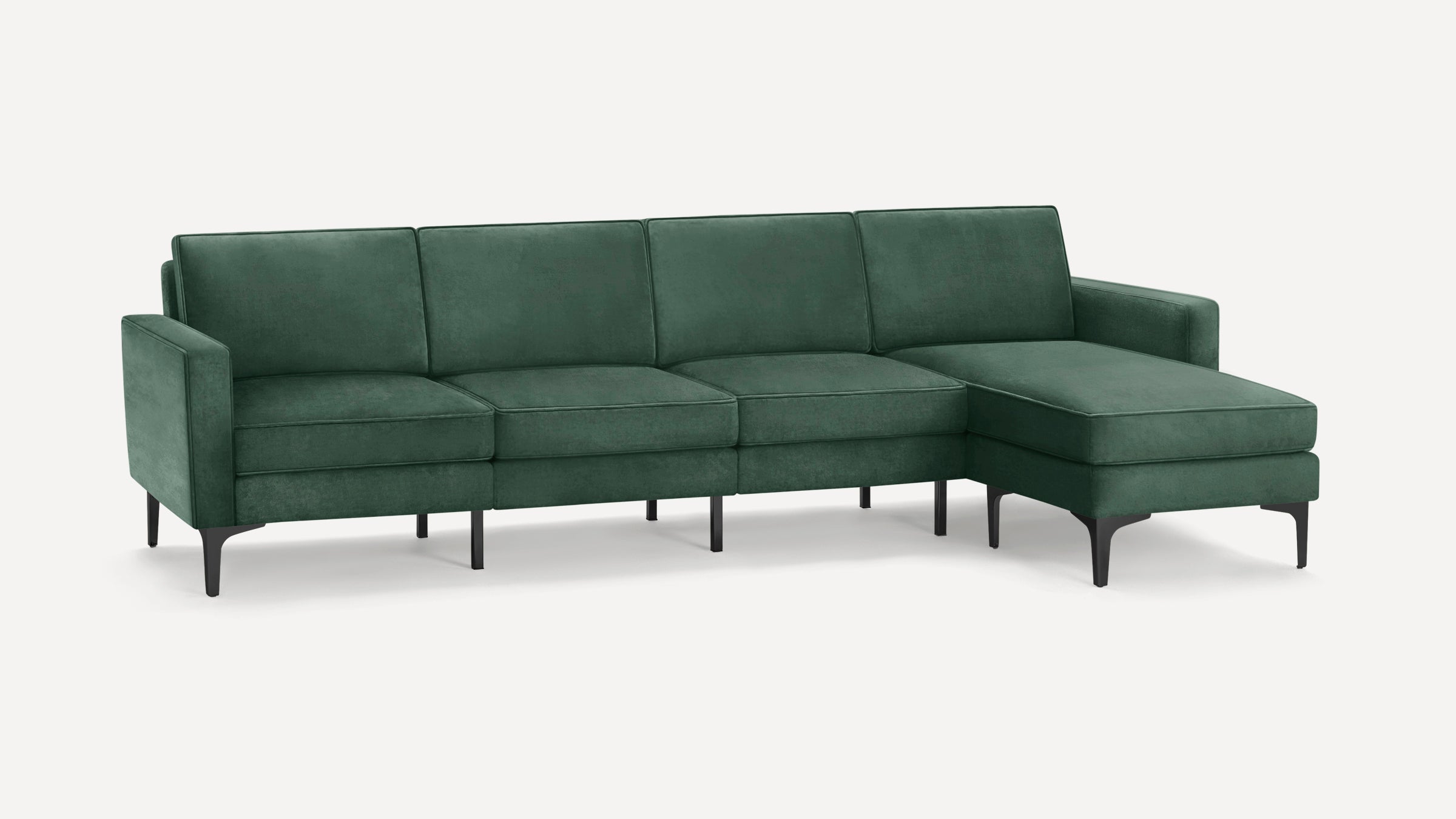Modern green velvet sectional sofa with clean lines, angled black legs, and a right-side chaise lounge on a white background.