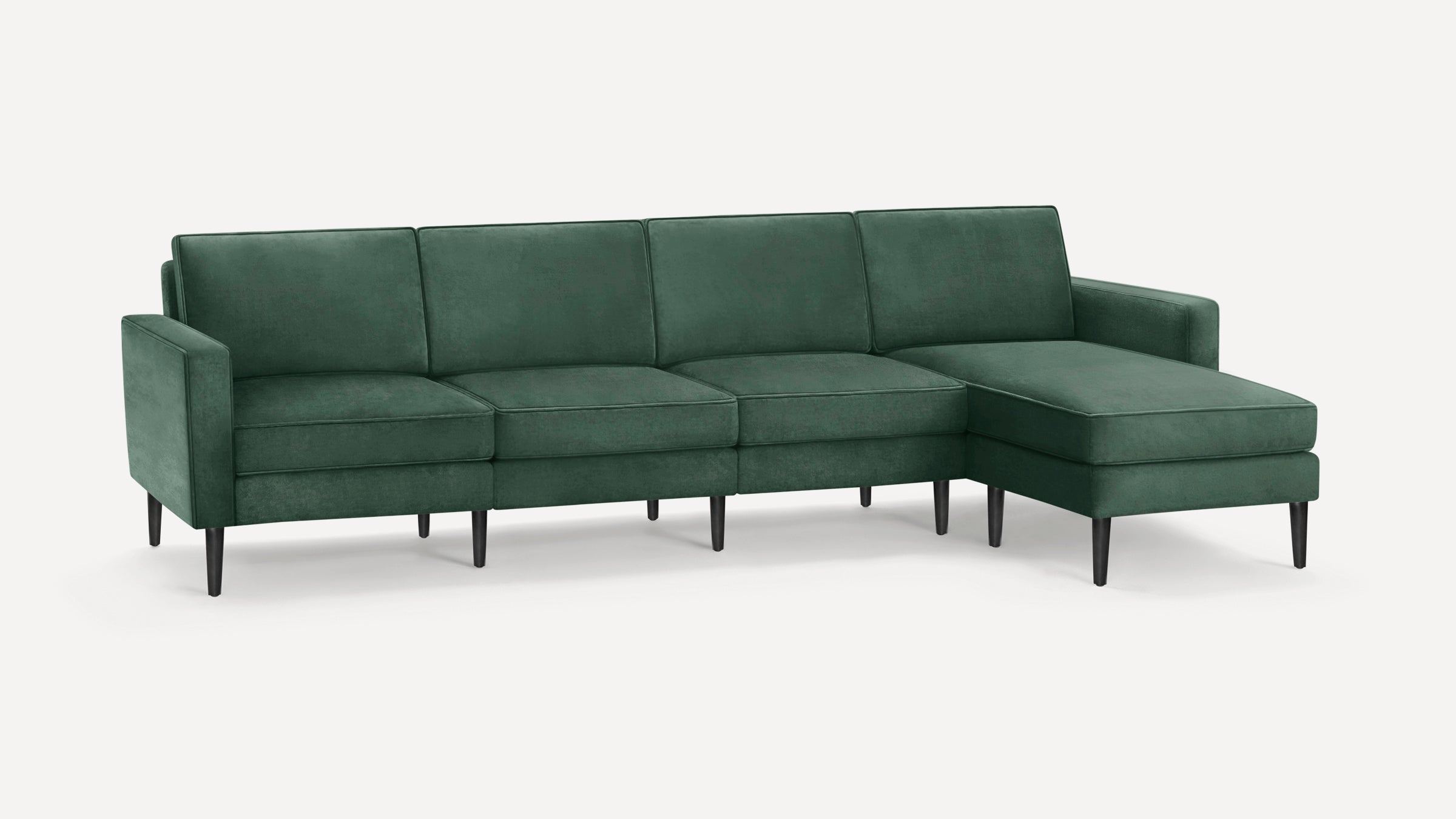 Modern dark green velvet sectional sofa with clean lines, black tapered legs, and right-side chaise lounge.