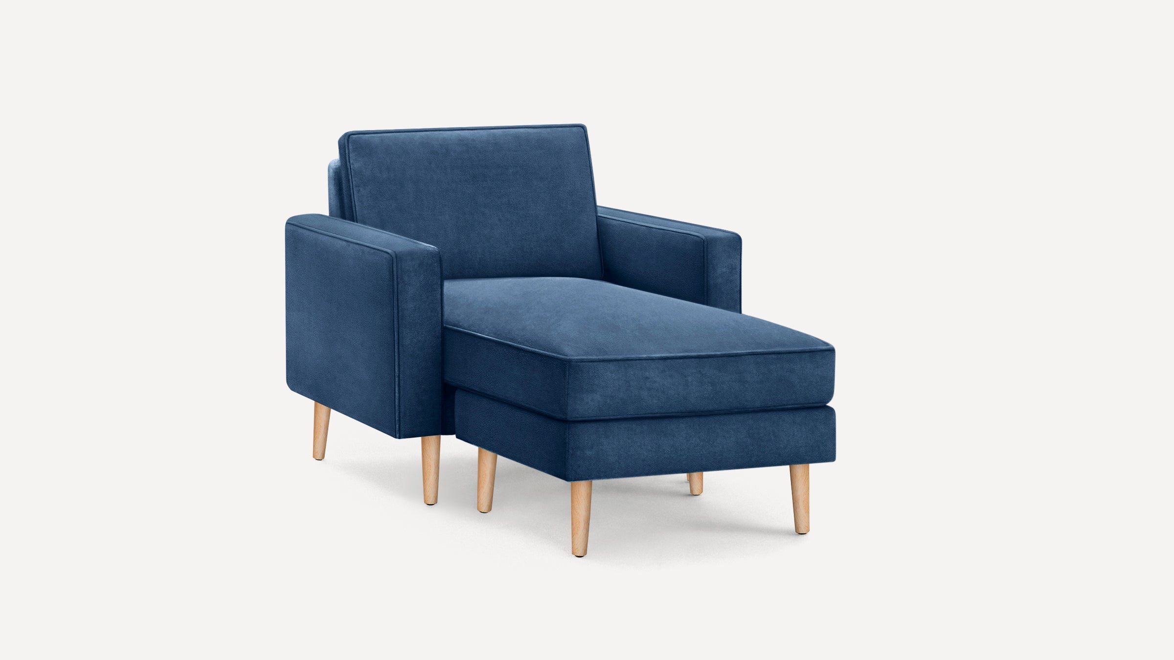 Modern blue velvet chaise lounge chair with wooden legs and straight armrests on a plain white background.