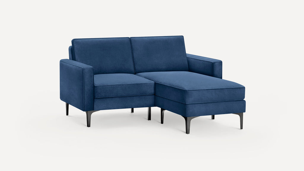 Blue upholstered chaise sectional sofa with sleek black tapered metal legs and modern clean-lined design.