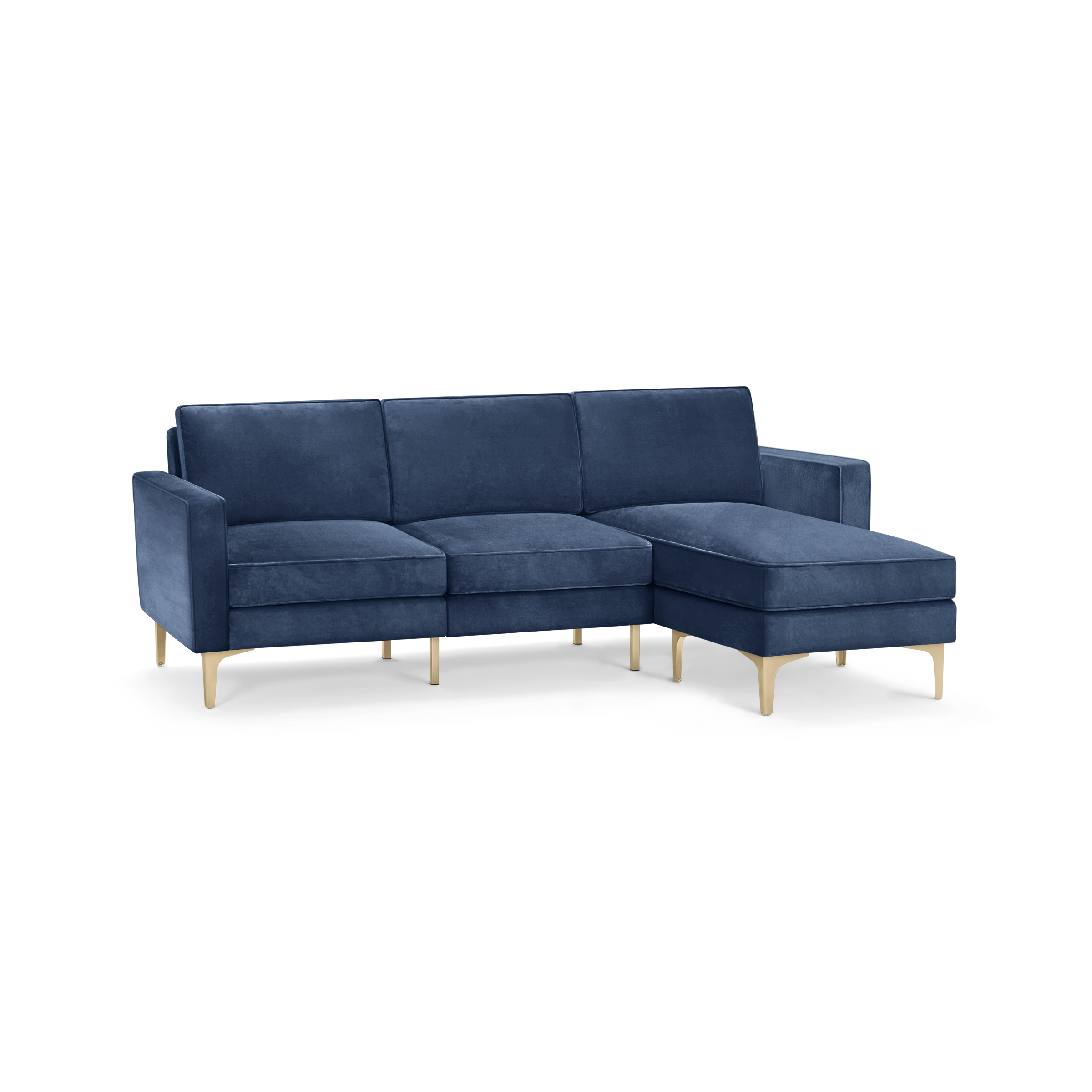modern blue velvet sectional sofa with wooden legs and clean lines on the back, featuring a chaise lounge and matching ottoman